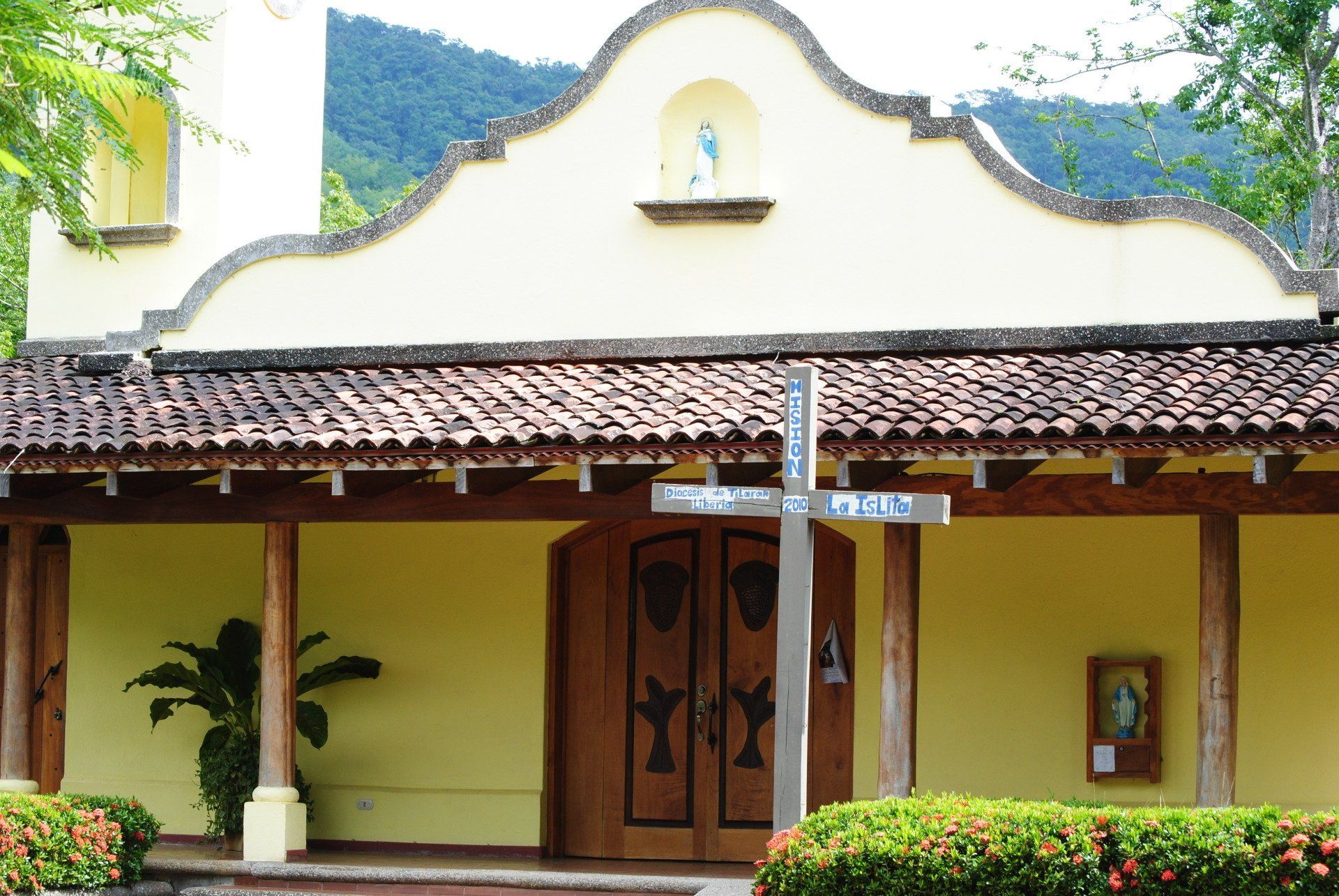 A small church with a cross in front of it