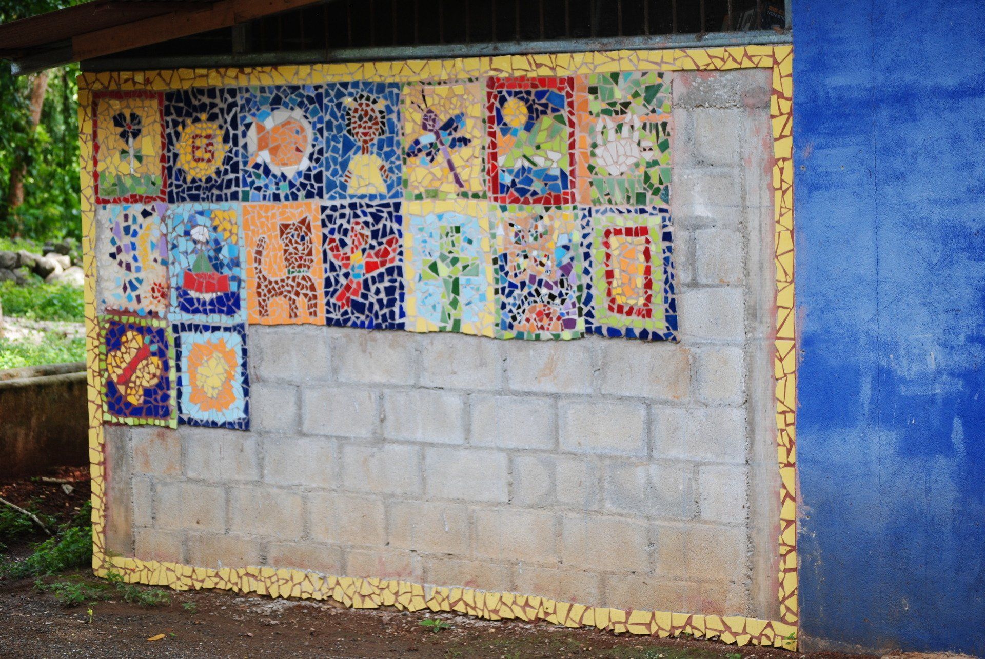 A brick wall with a collage of pictures on it