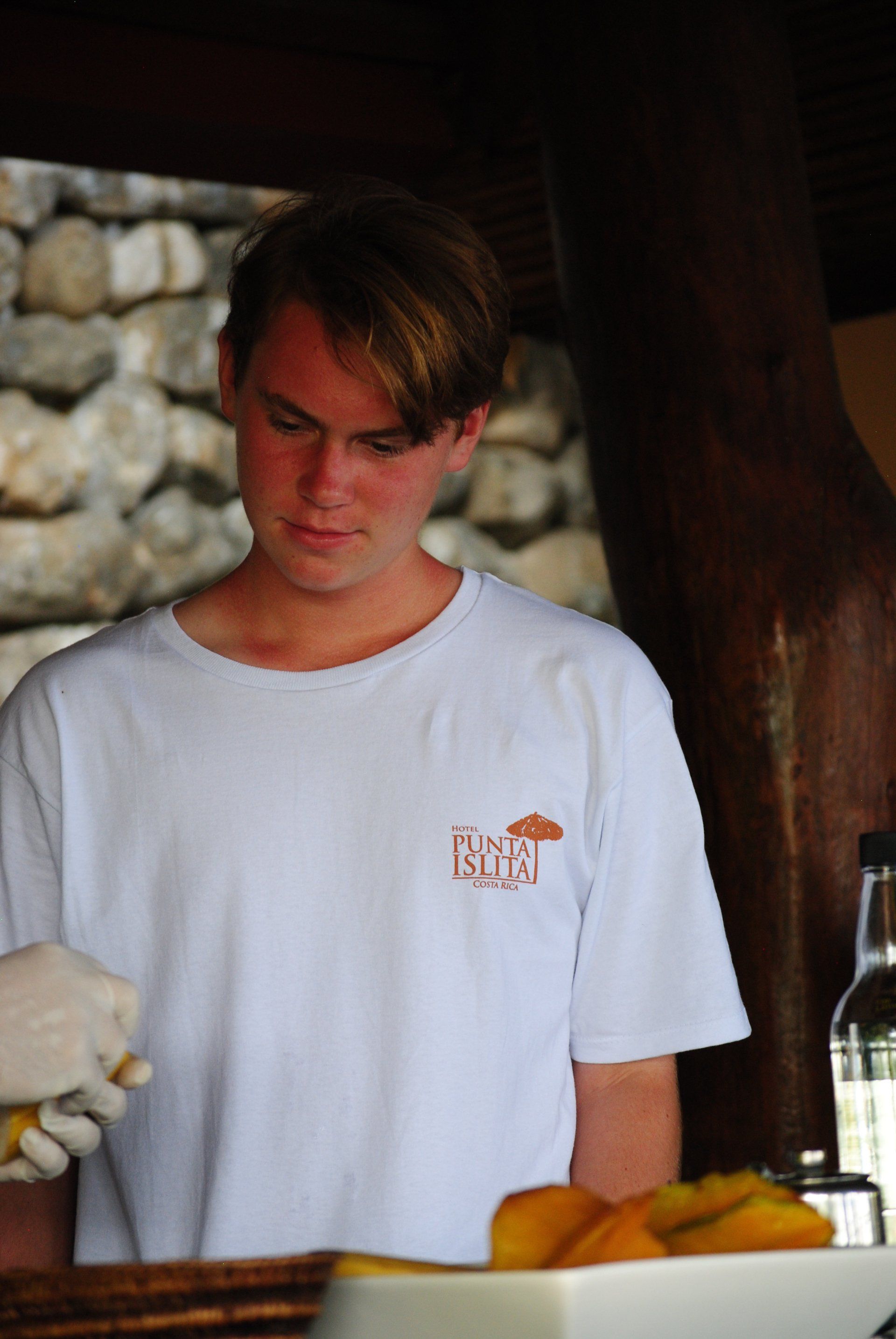 A man wearing a white shirt with the word island on it