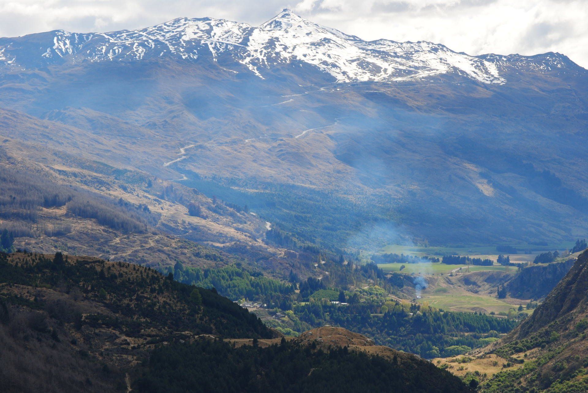 A view of a valley with mountains in the background