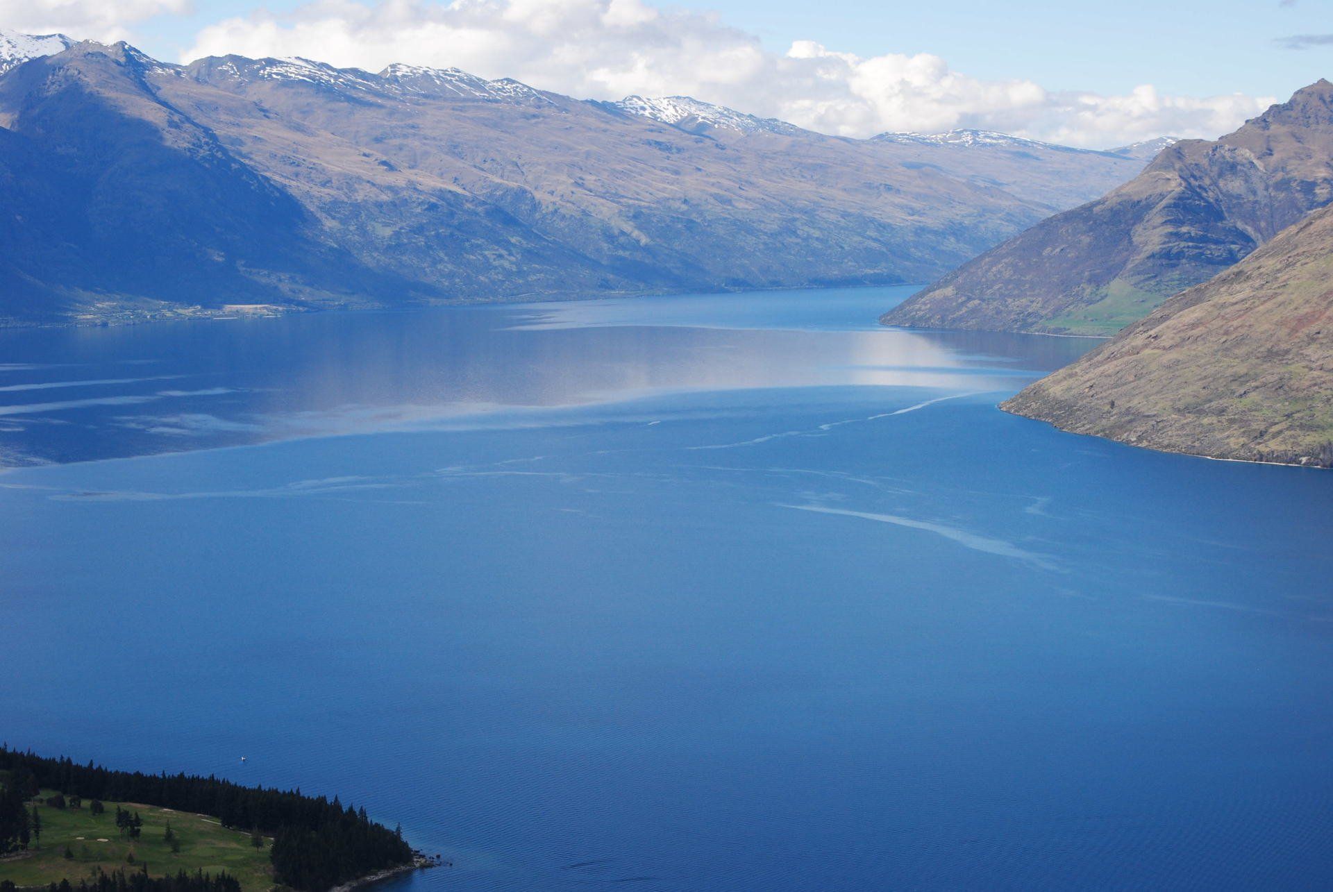 An aerial view of a large body of water surrounded by mountains.