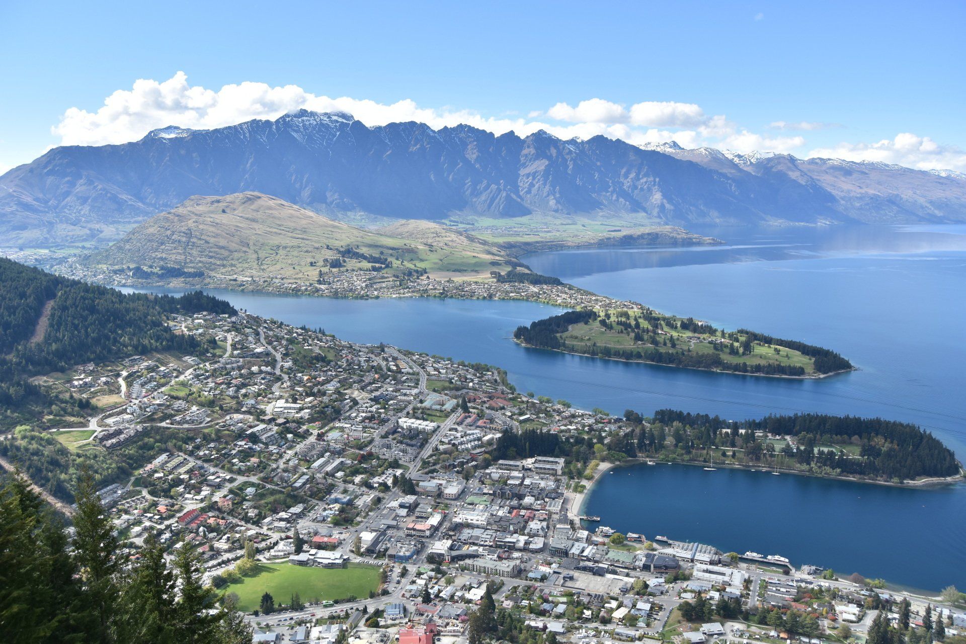 An aerial view of a city surrounded by water and mountains