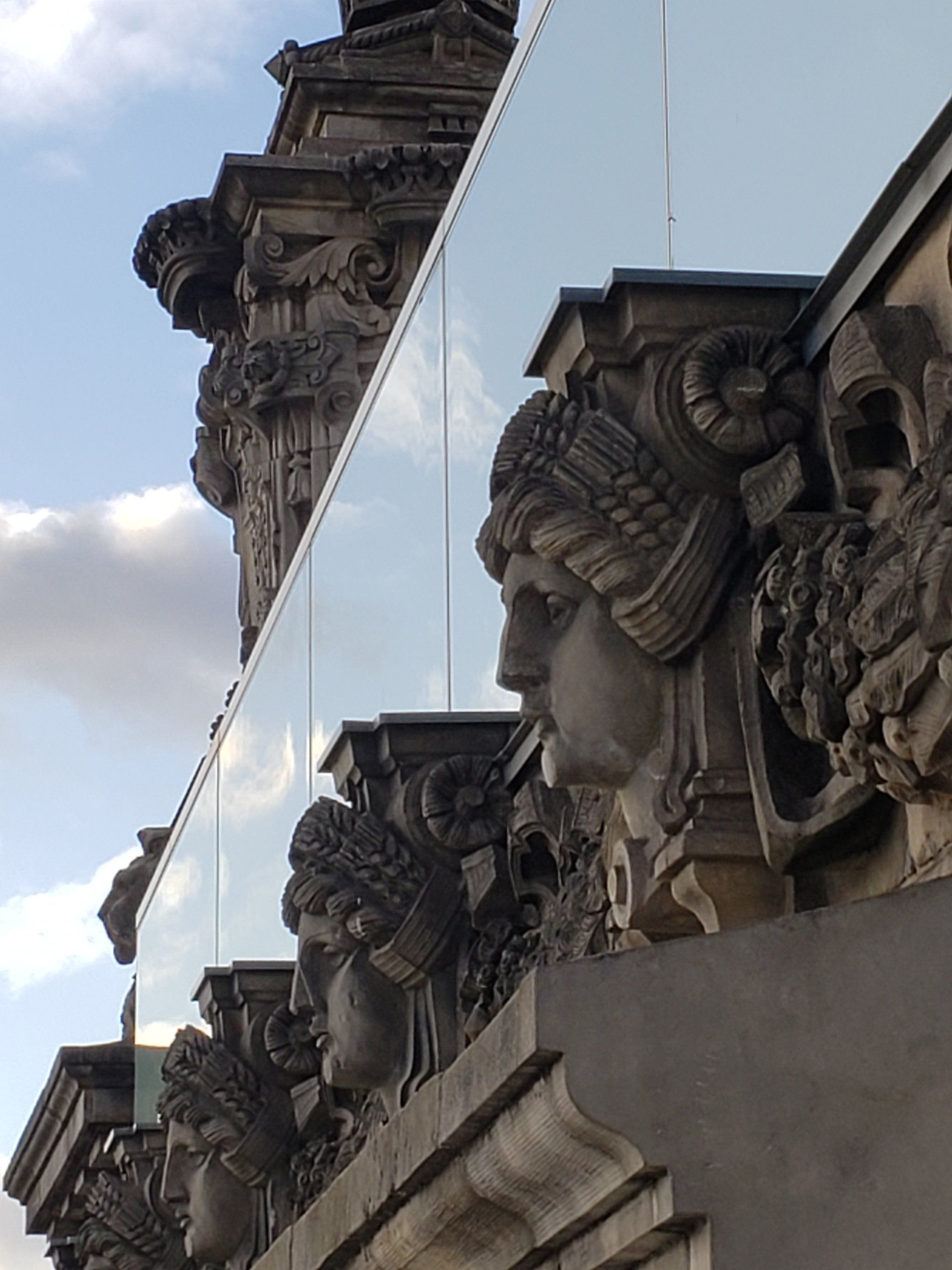 A row of statues on the side of a building
