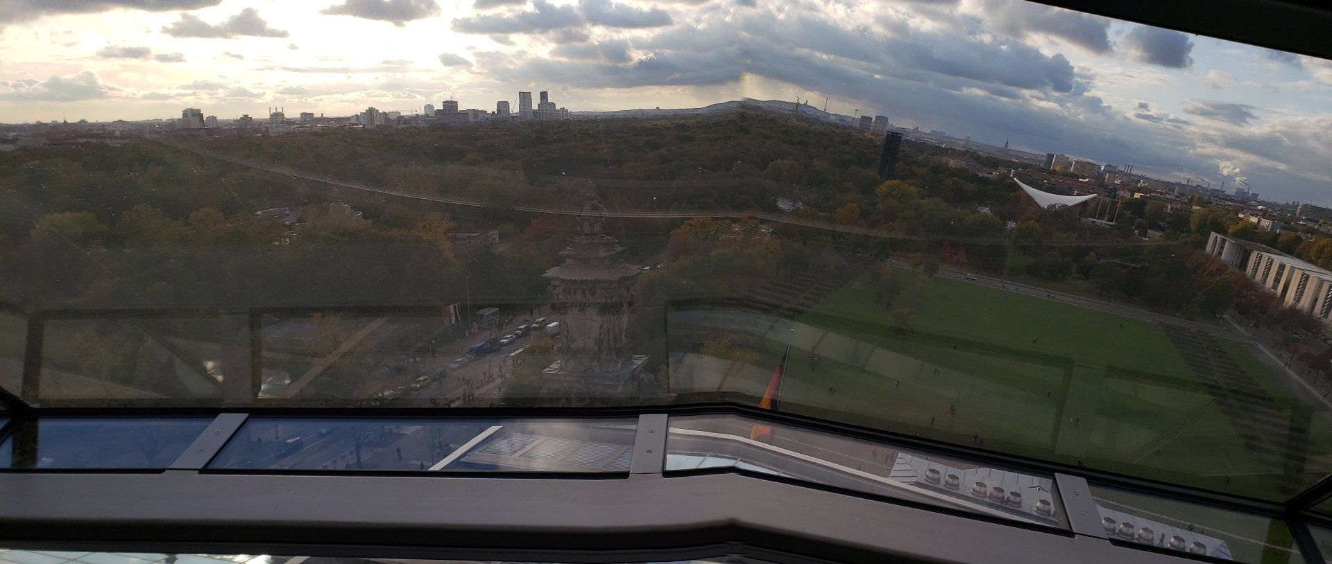 A view of a city from the inside of a ferris wheel.