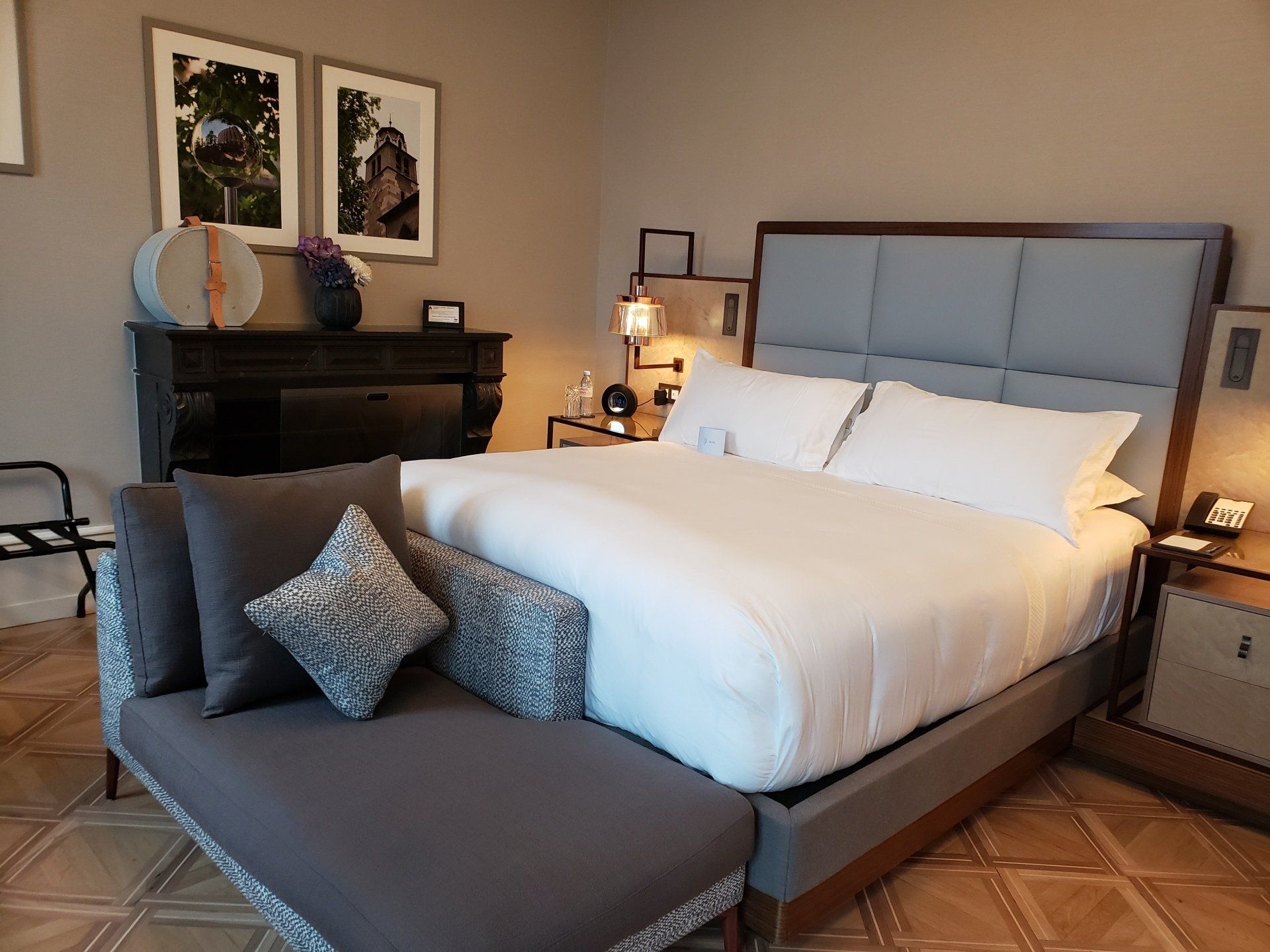 A hotel room with a large bed and a couch