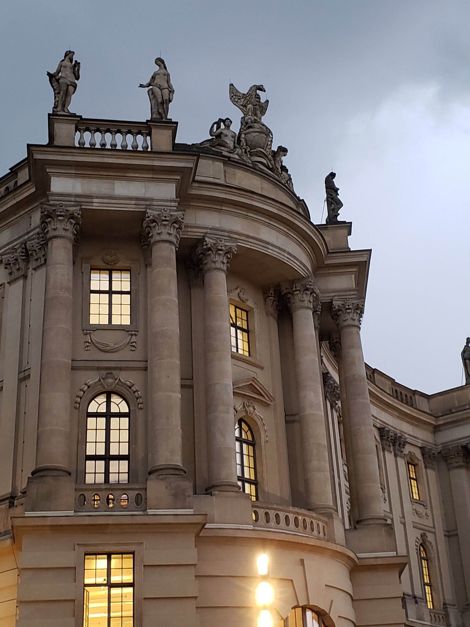 A large building with columns and statues on top of it
