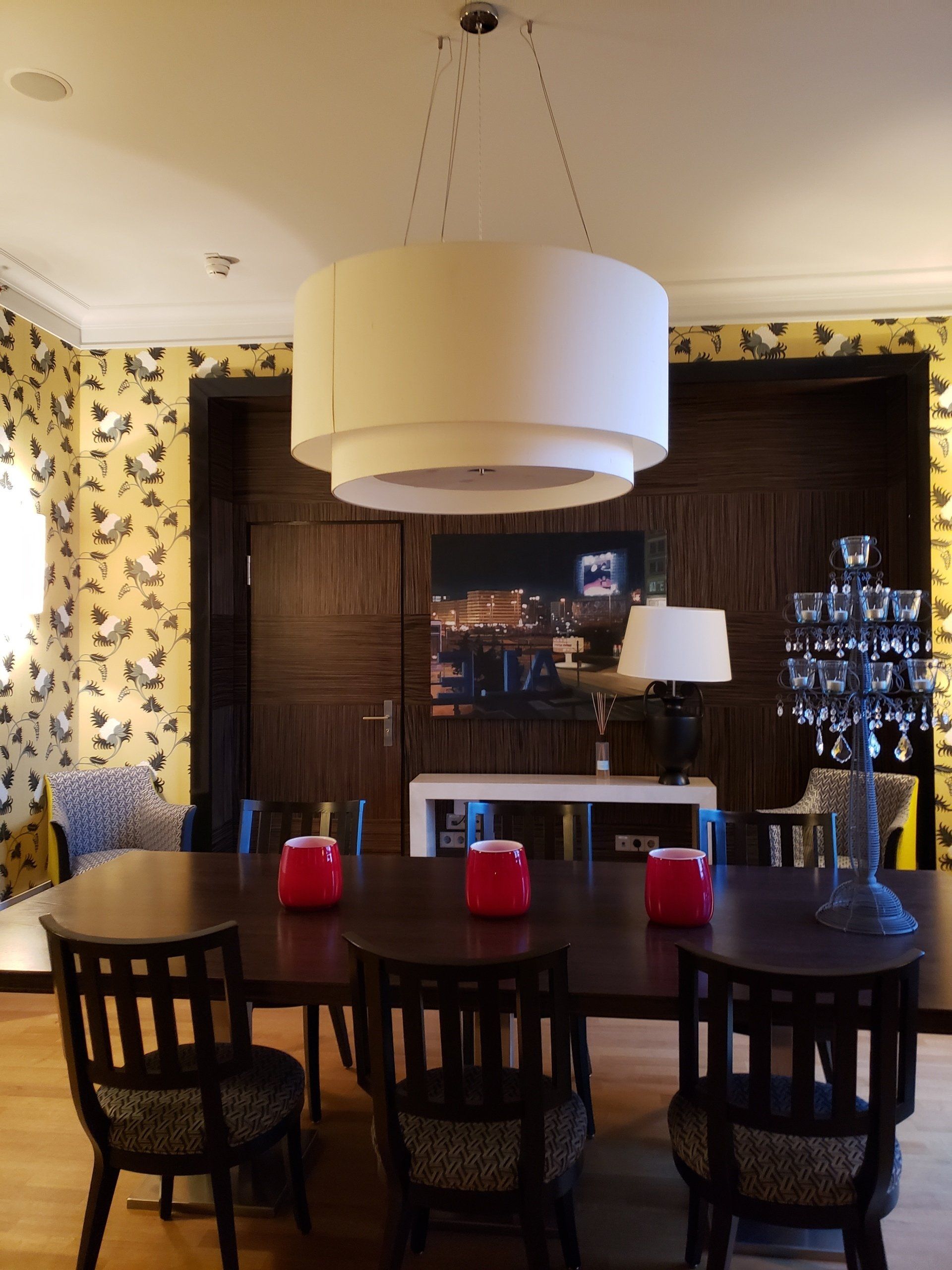 A dining room with a table and chairs and a chandelier
