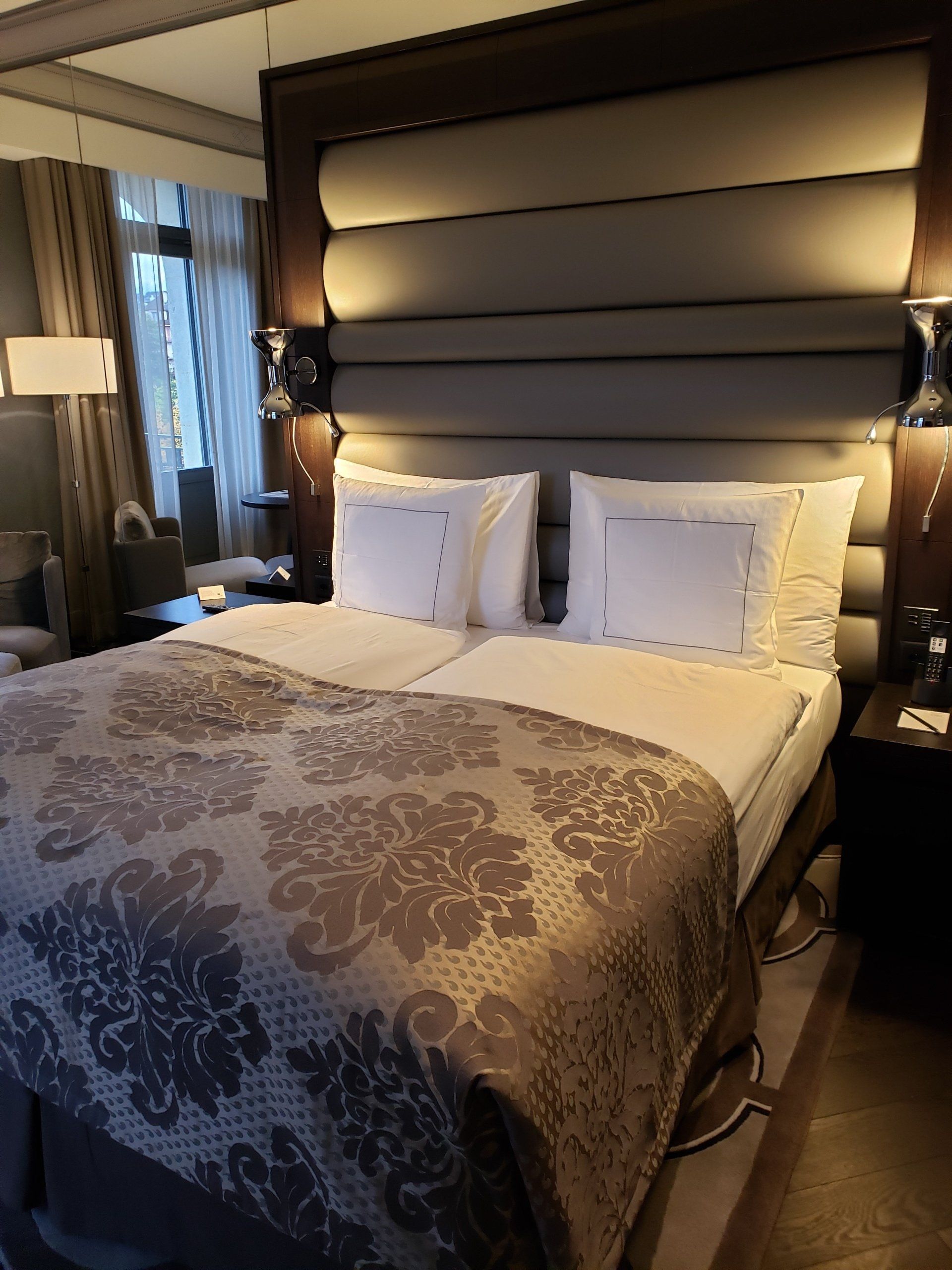 A hotel room with a large bed and pillows