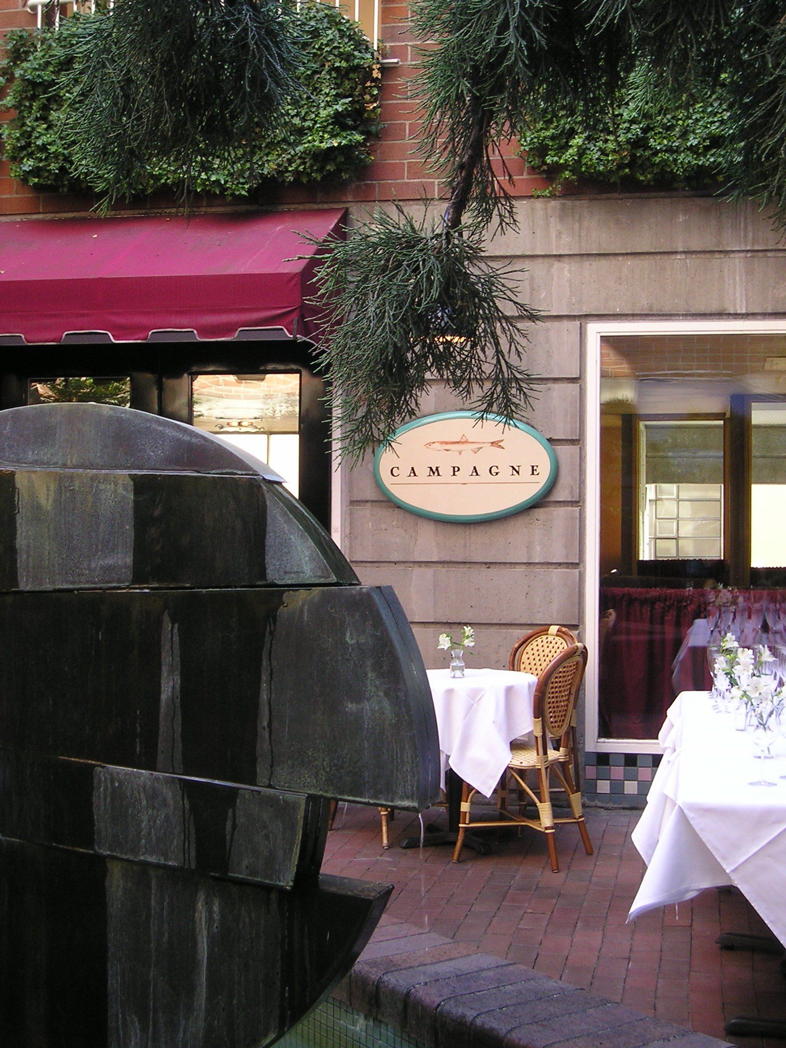 A restaurant with a fountain in front of it