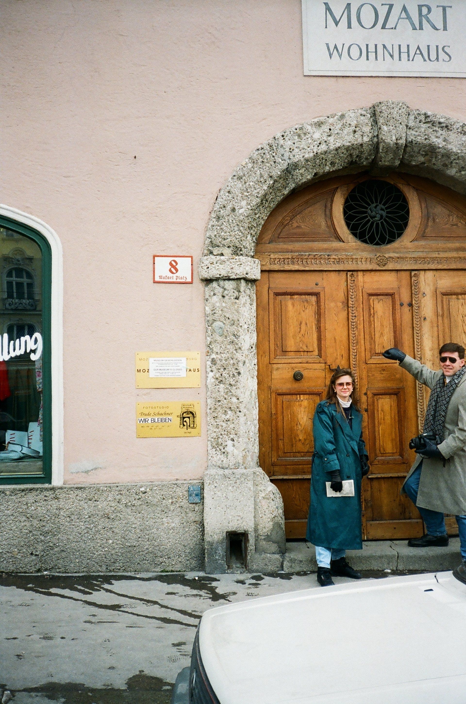 Two people standing in front of a door that says mozart