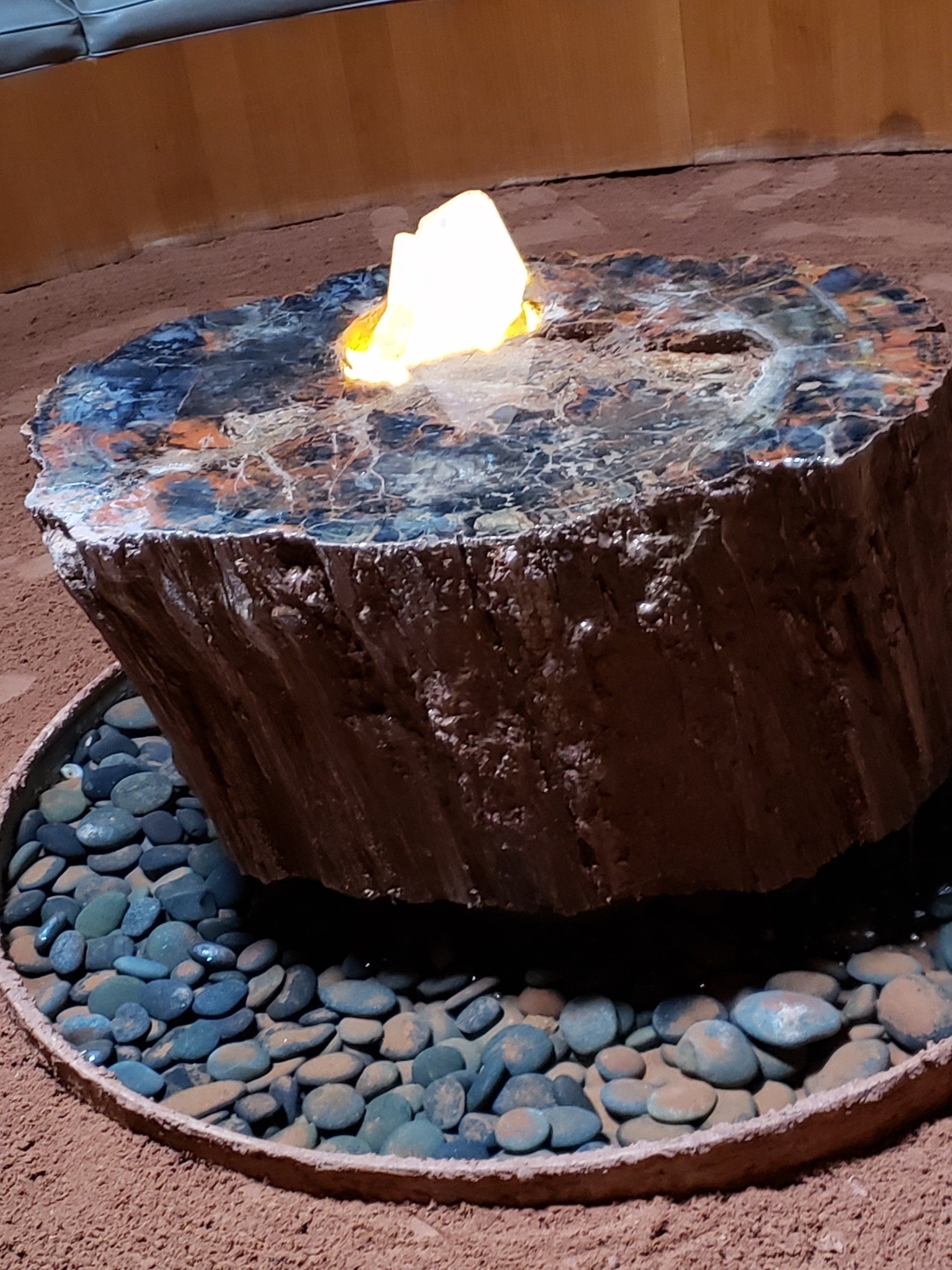 A large piece of wood is sitting on top of a pile of rocks