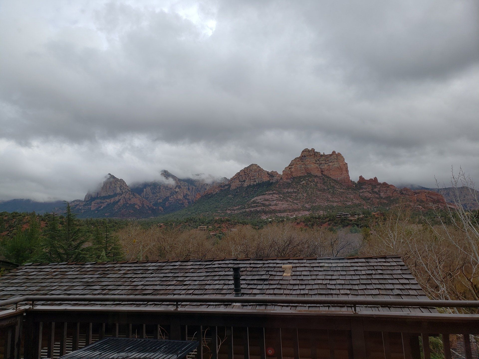 A view of mountains from a deck on a cloudy day
