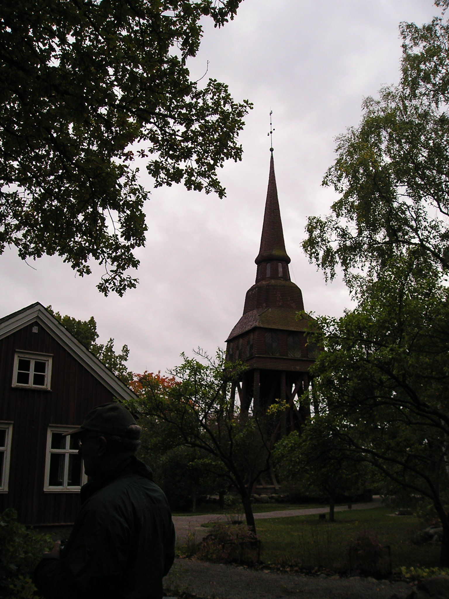 A silhouette of a building with a steeple in the background