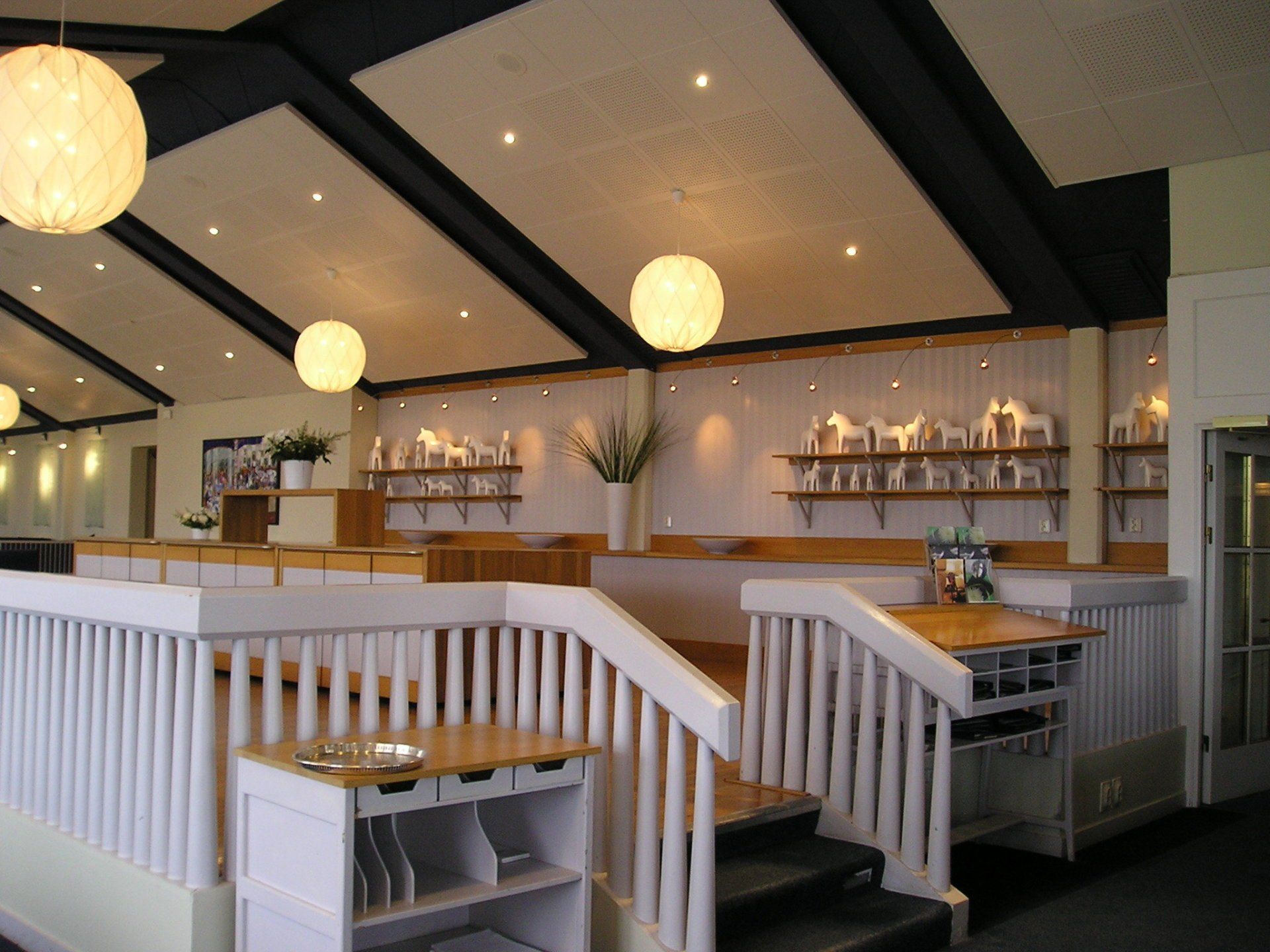 A restaurant with stairs leading up to the second floor