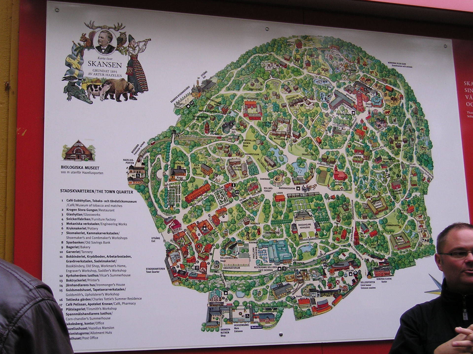 A man stands in front of a large map of a park