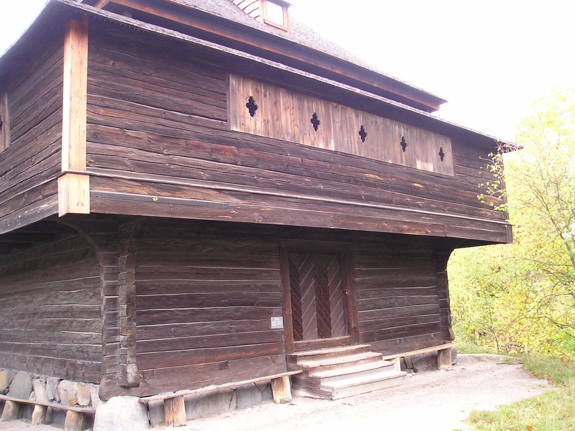 A large wooden building with stairs leading up to it