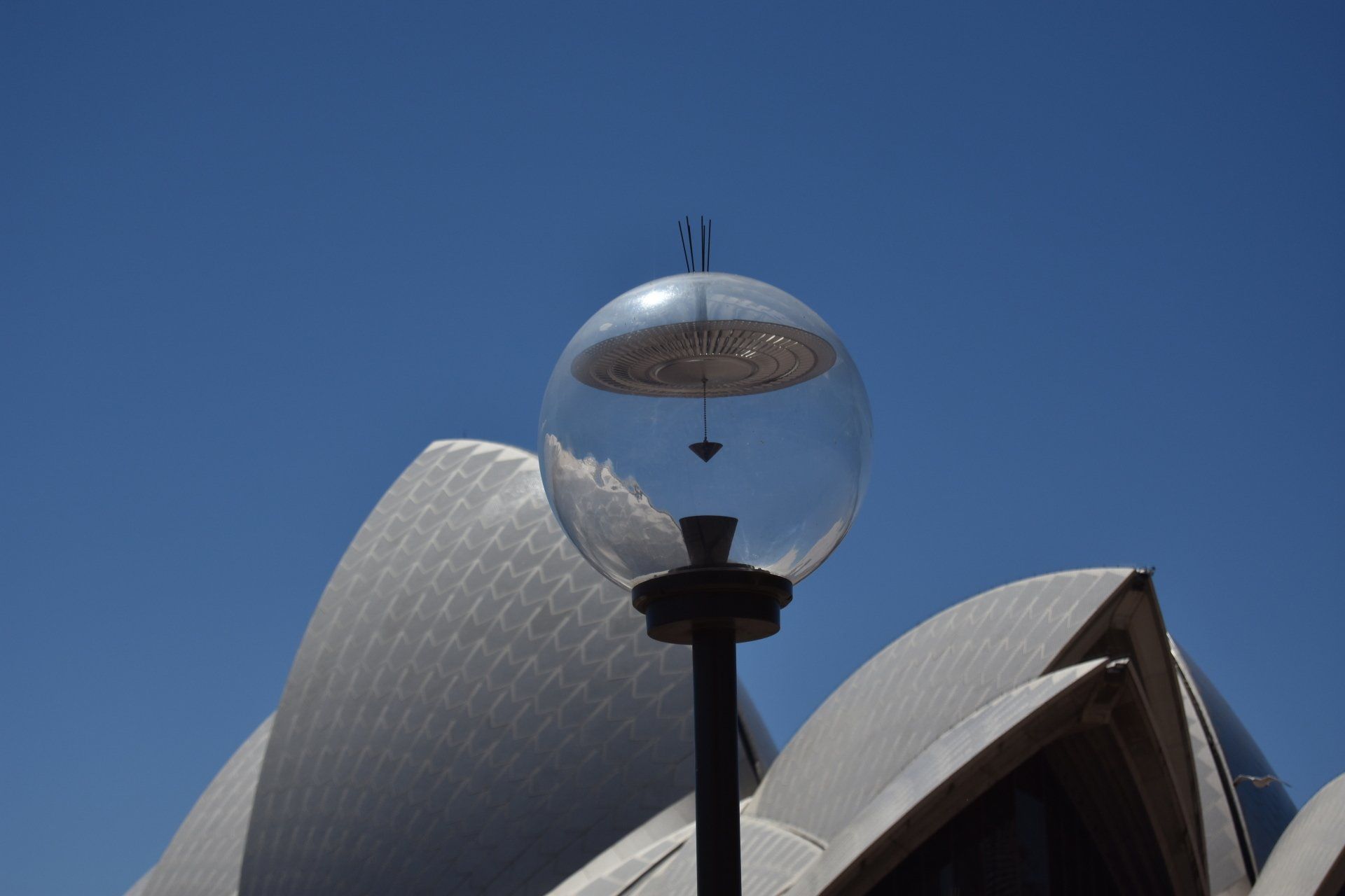 A street light in front of the opera house in sydney