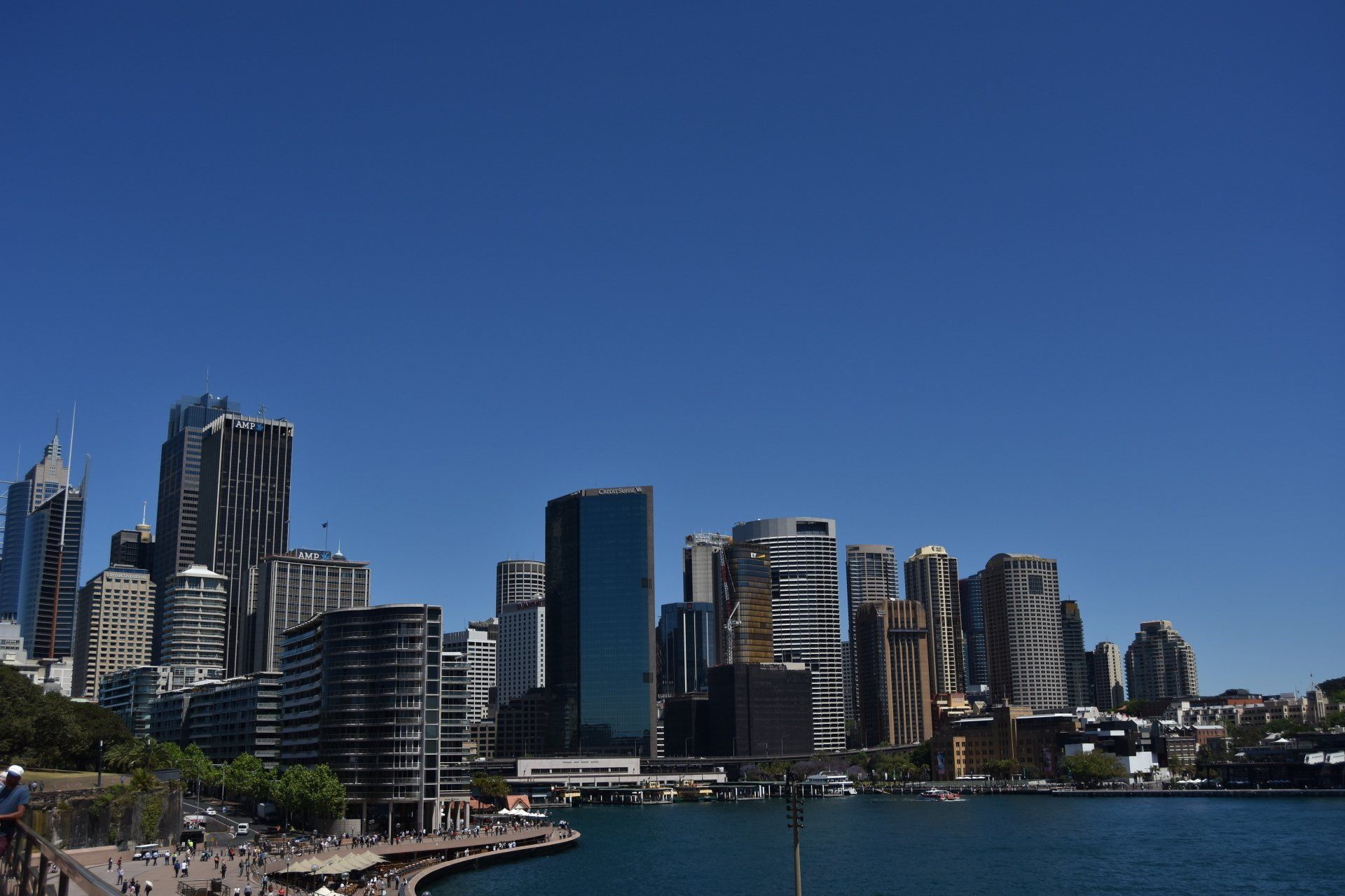 A city skyline with a body of water in the foreground