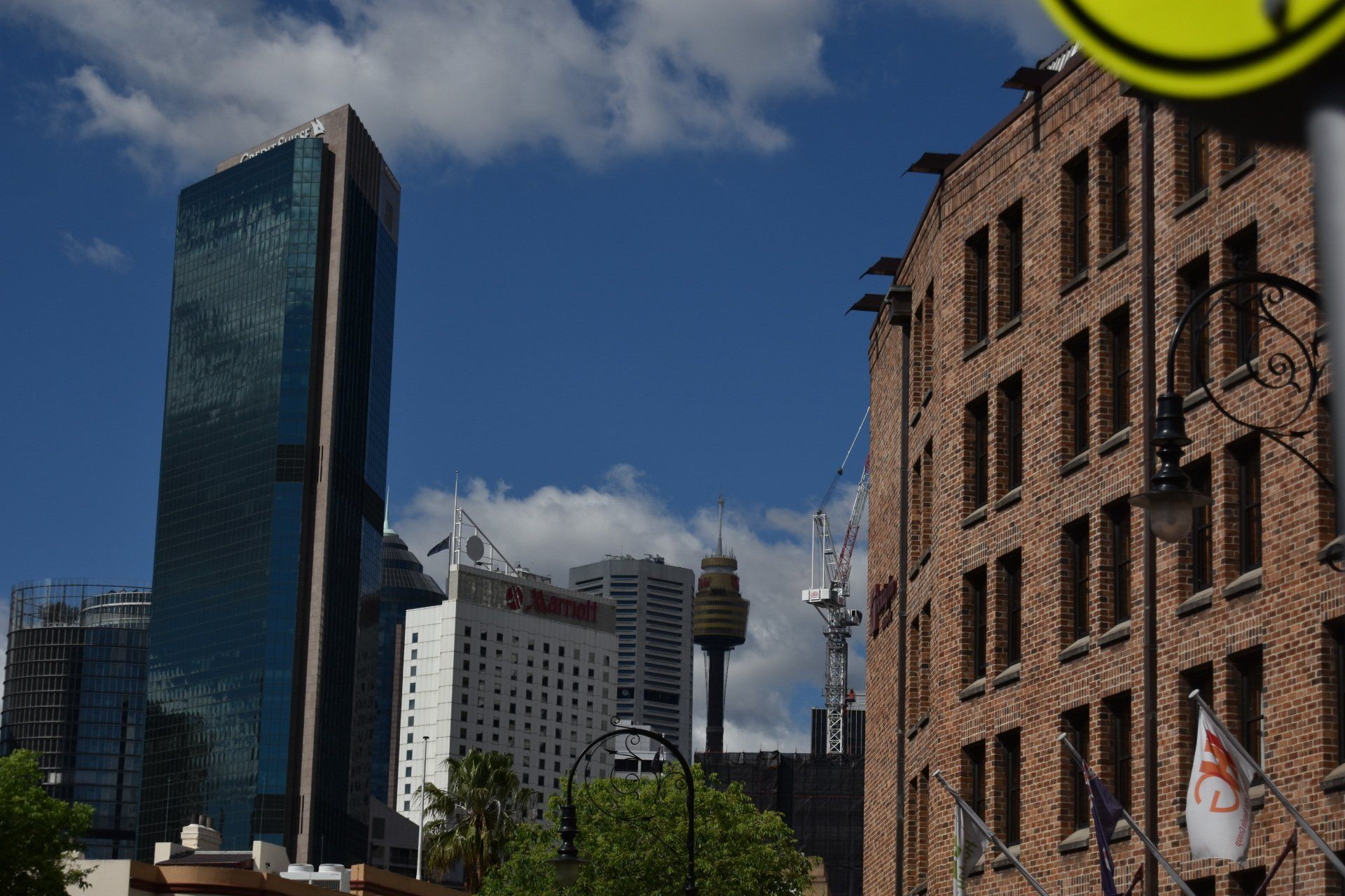 A brick building with a tall building in the background