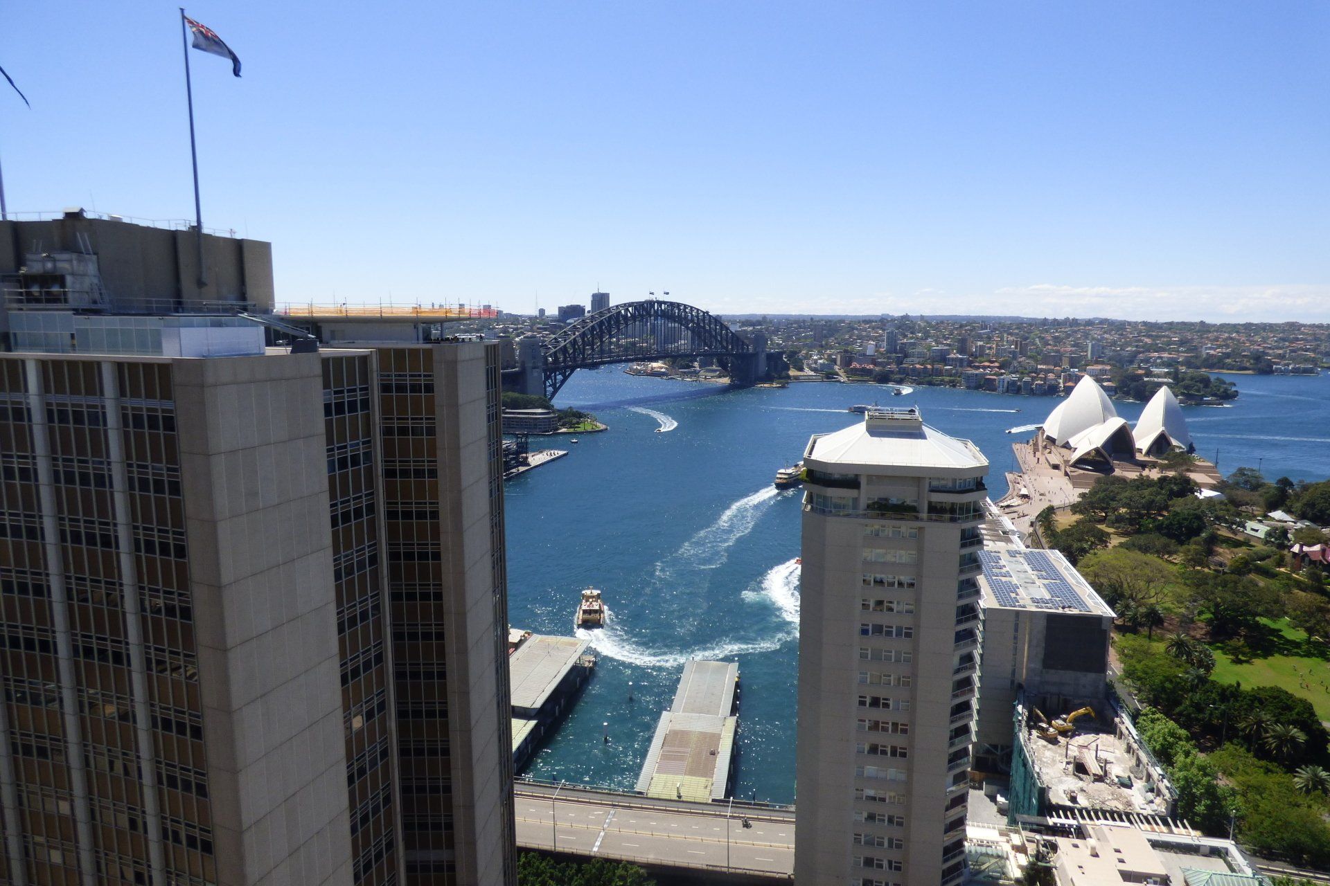 An aerial view of a city with a bridge in the background