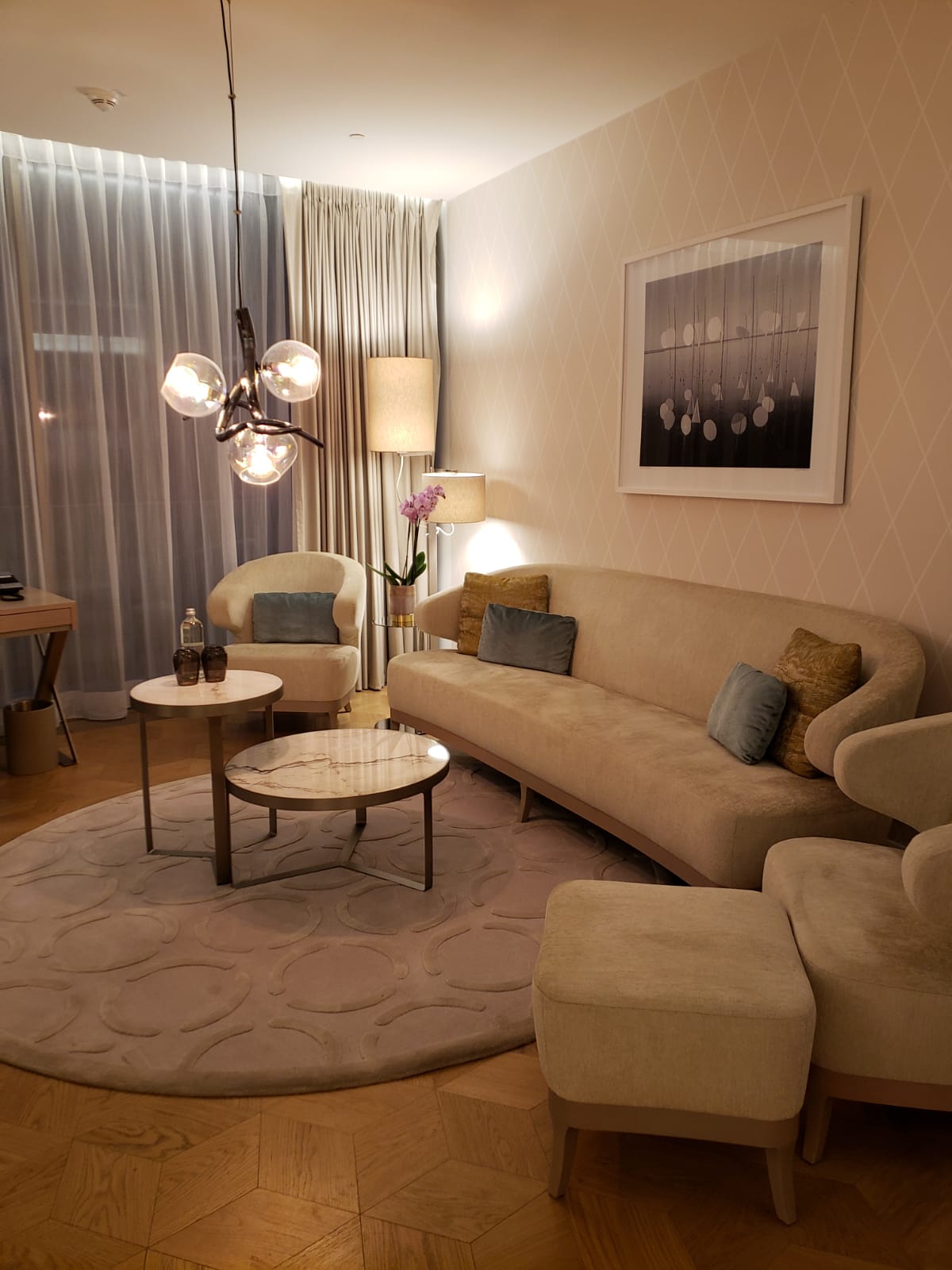 A living room with a couch , chairs , and a coffee table.