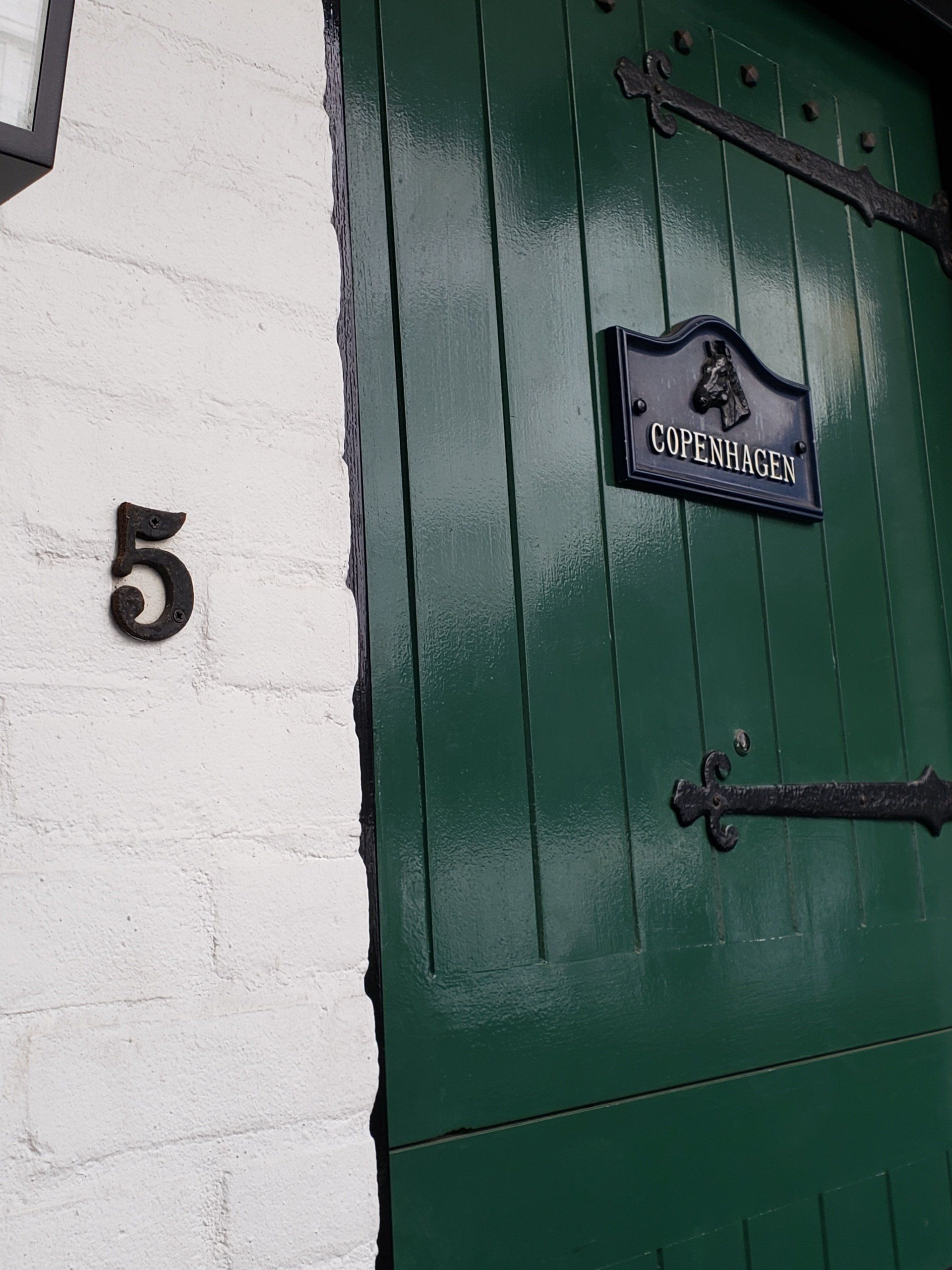 A green door with the number 5 on it