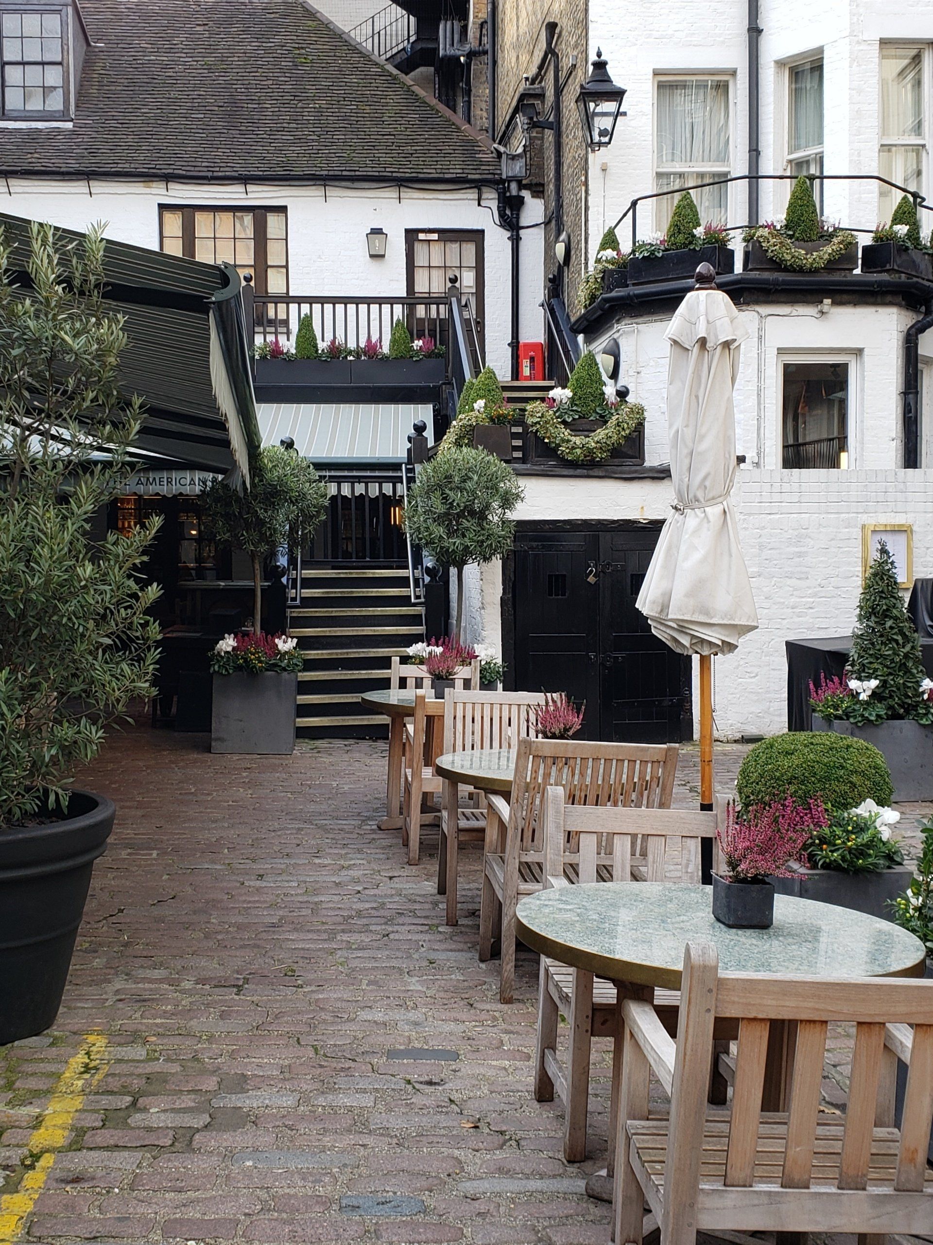 A row of tables and chairs in front of a building
