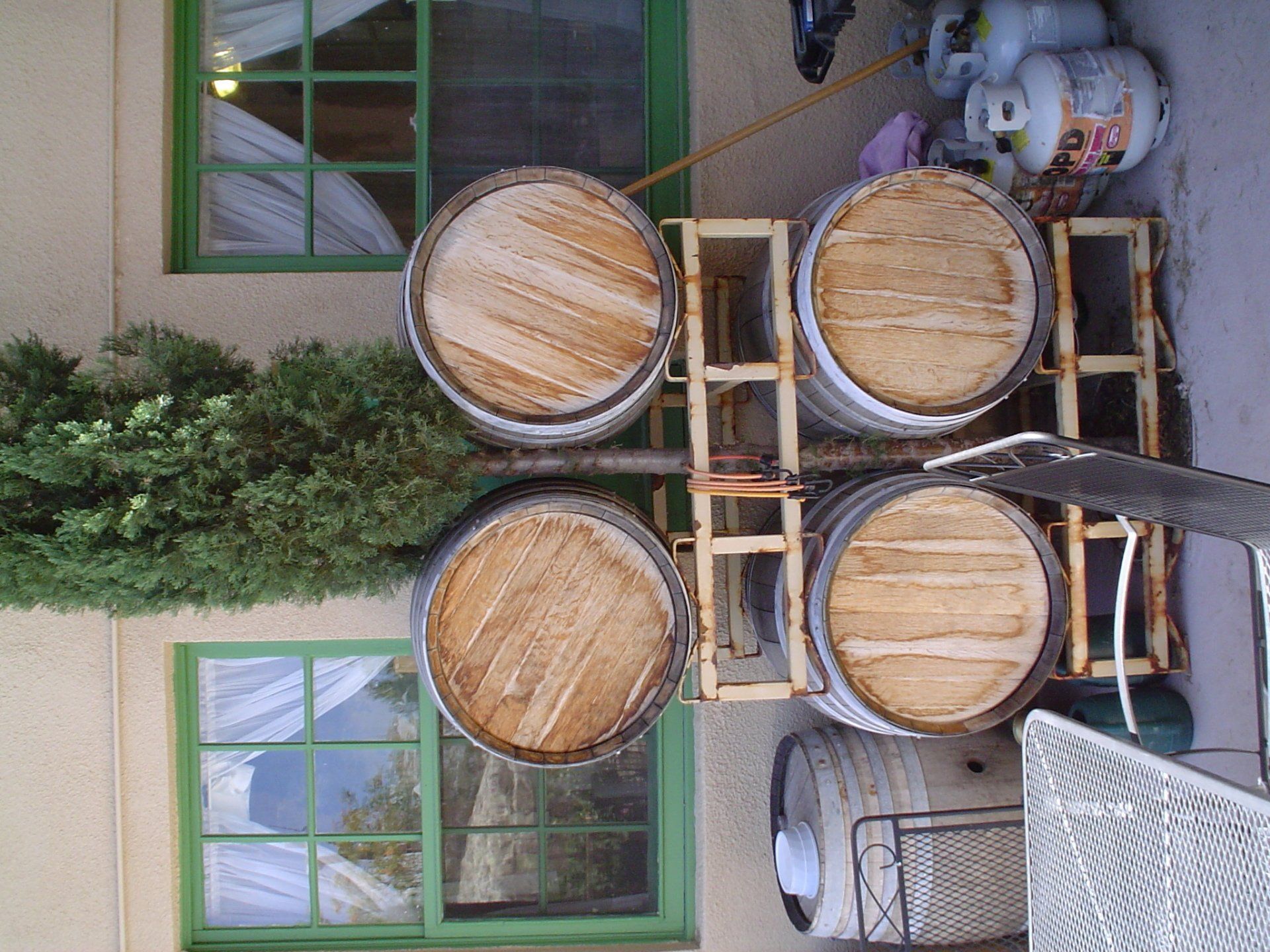 A bunch of wooden barrels are stacked on top of each other