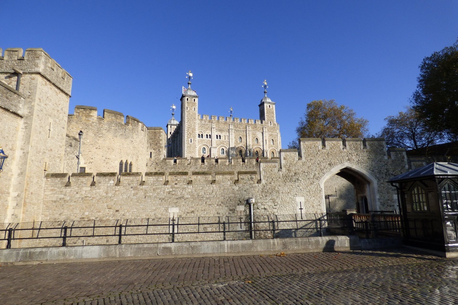 A large stone castle with a gate in front of it.