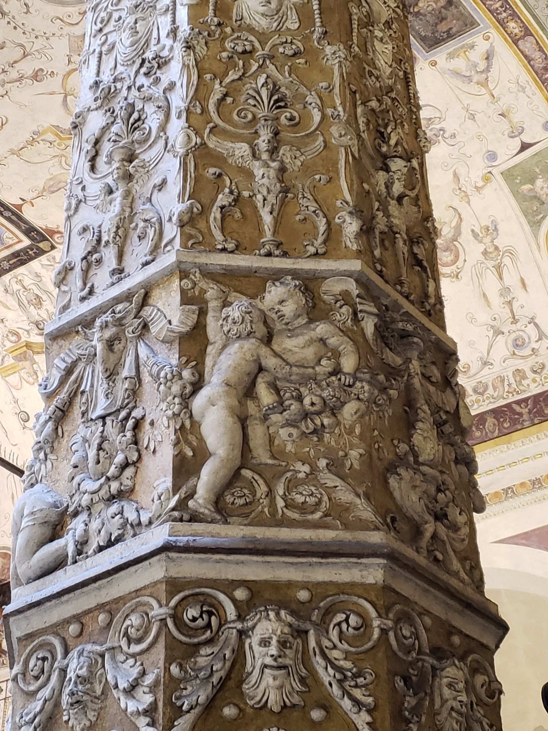 A pillar with a lot of carvings on it