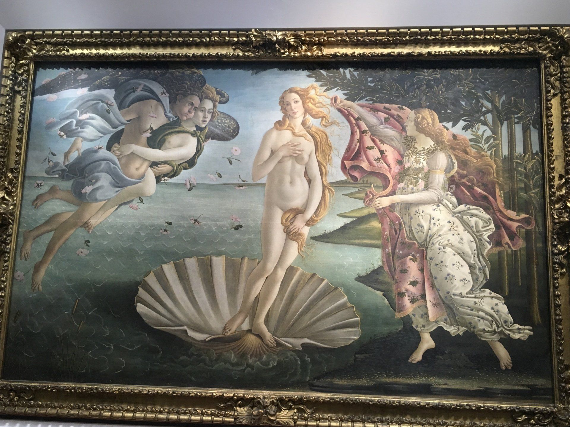 A framed painting of the birth of venus