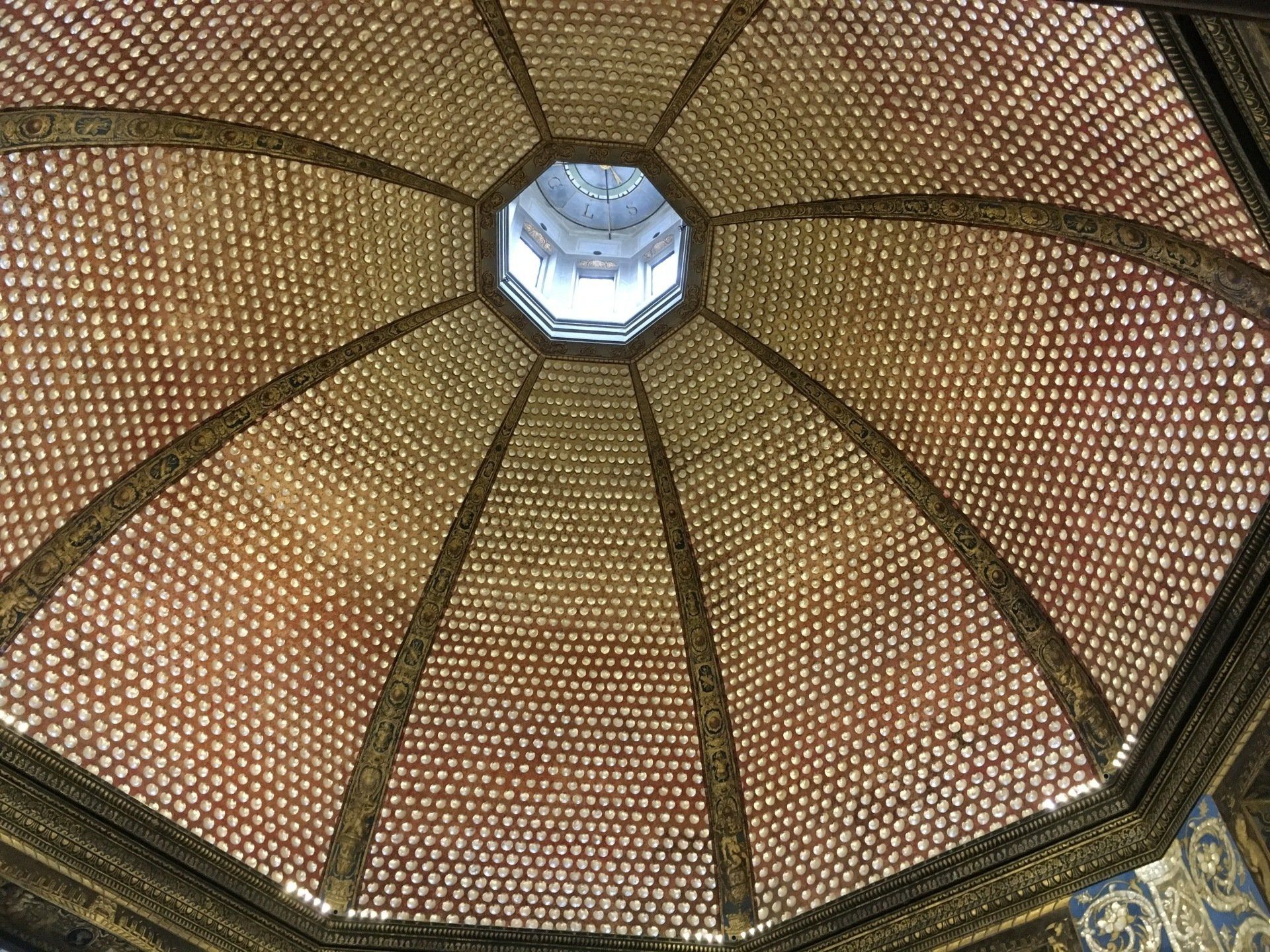 Looking up at the ceiling of a building with a dome.