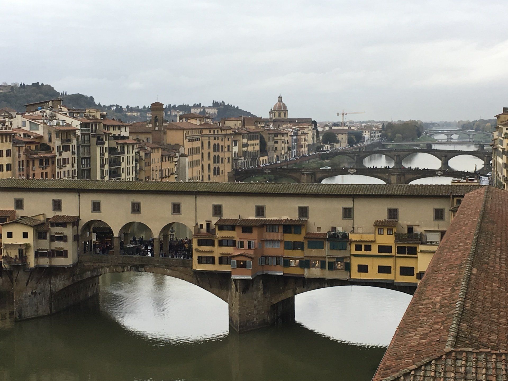 A bridge over a river with buildings in the background