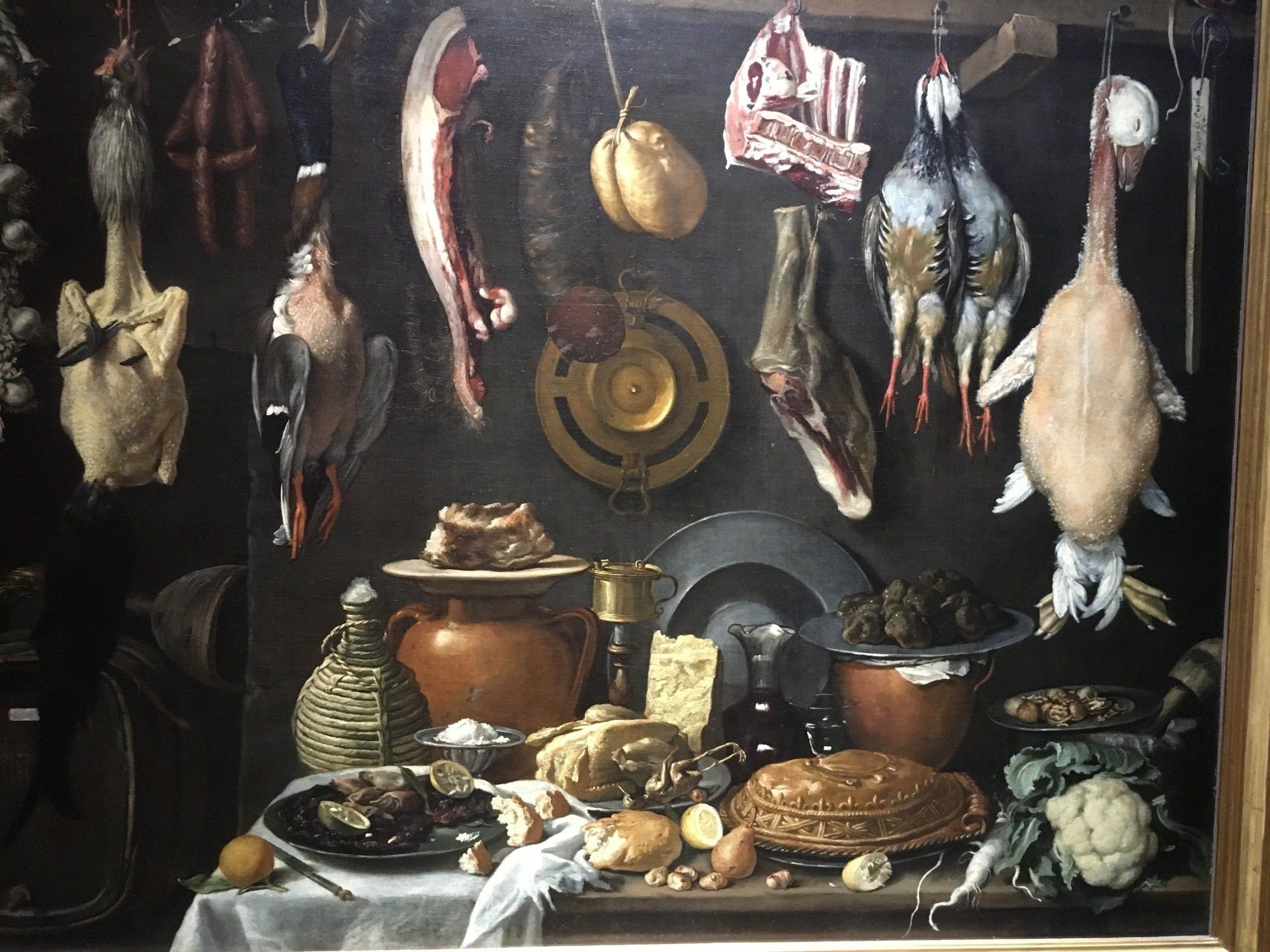 A painting of a table with meat and vegetables on it