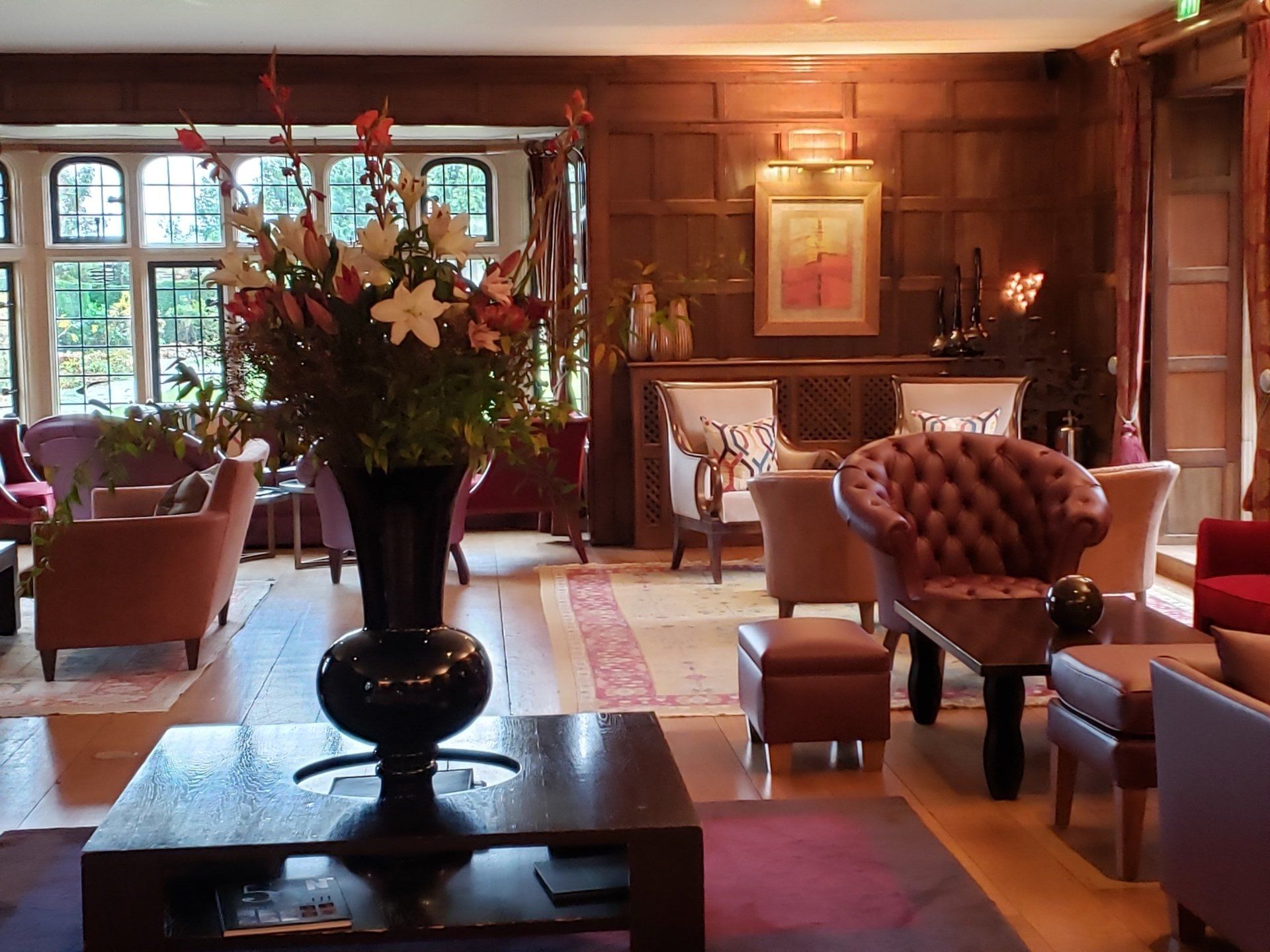 A living room filled with furniture and a vase of flowers