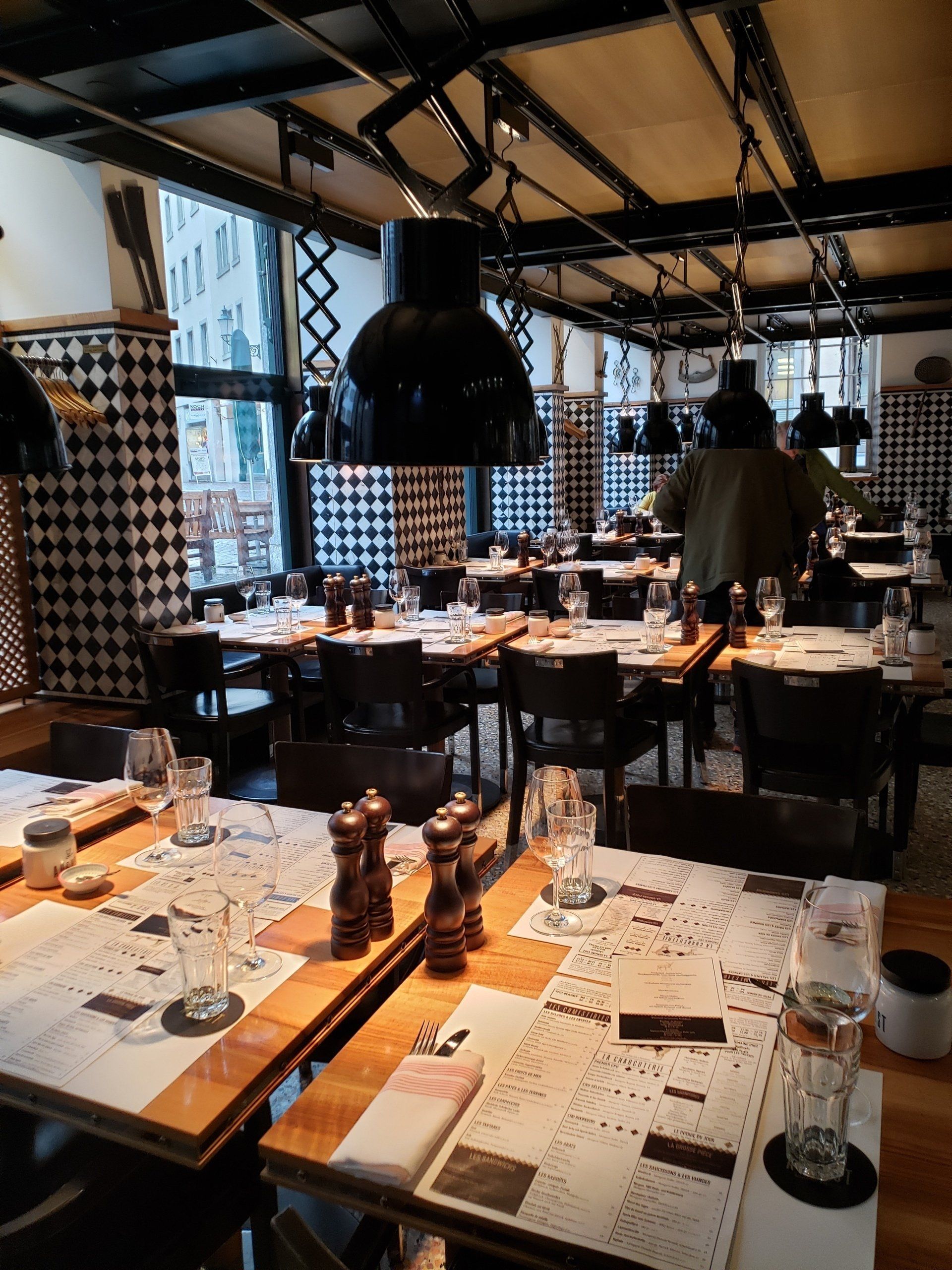 A restaurant filled with tables and chairs and glasses of wine