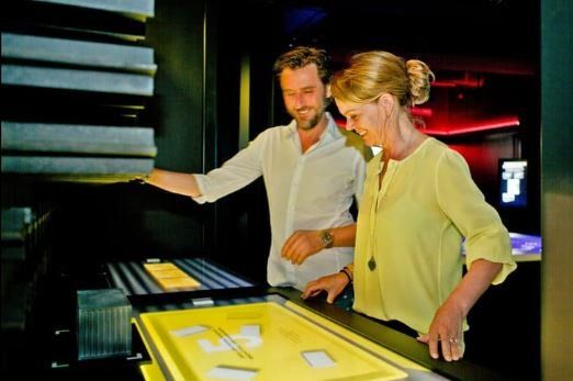 A man and a woman are looking at a yellow box