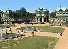 A large palace with a fountain in the middle of it.