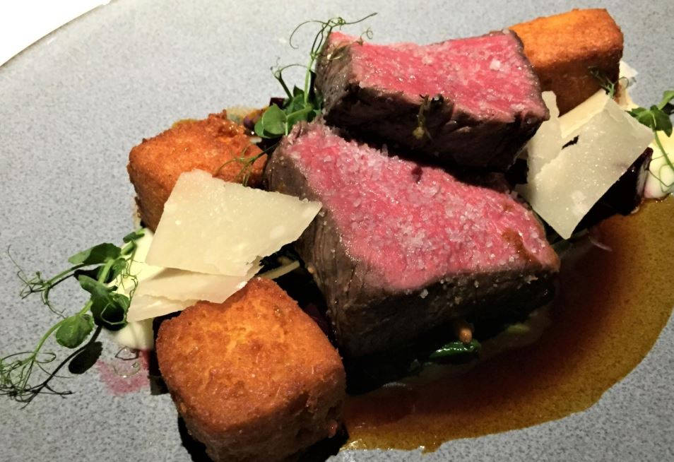 A close up of a plate of food with meat and vegetables