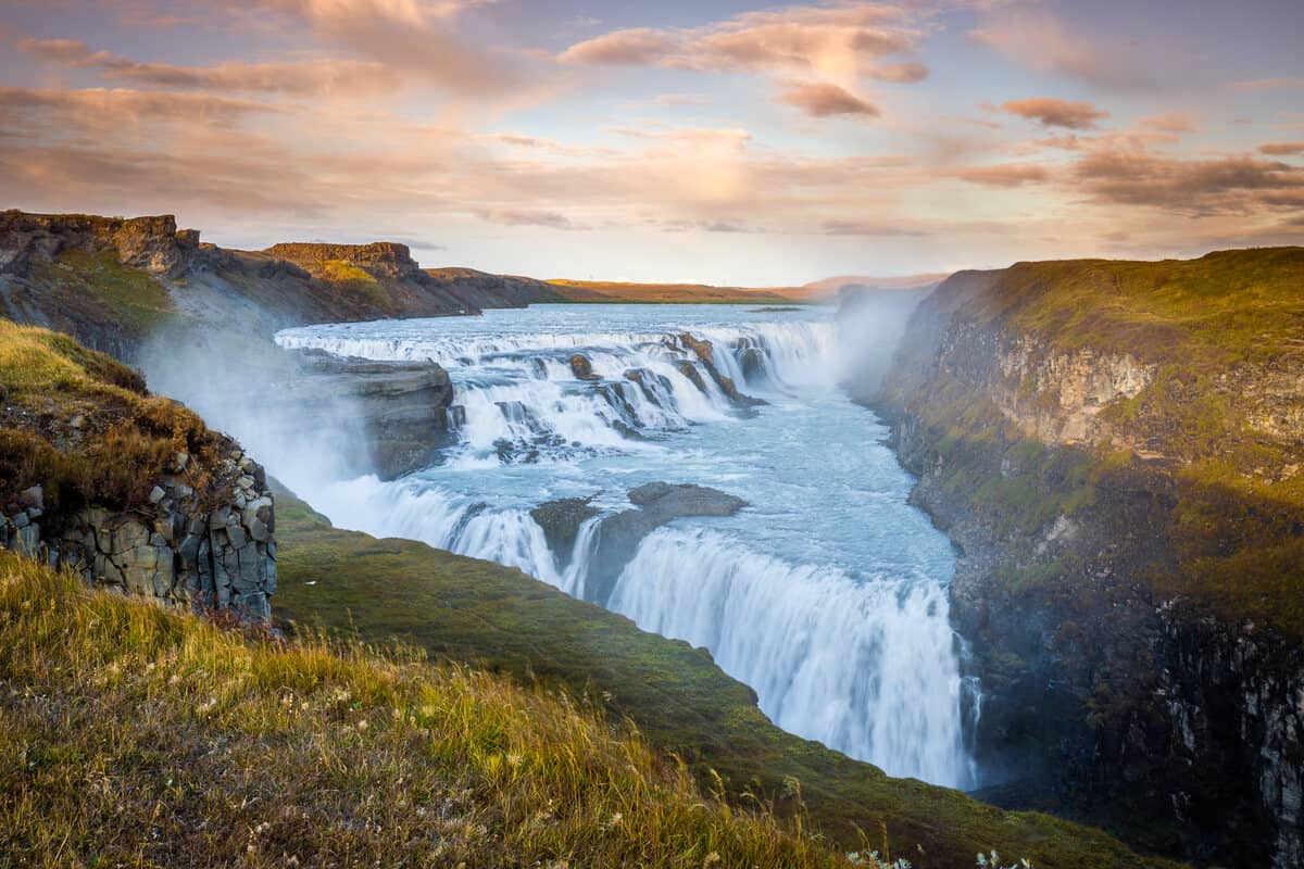 There is a waterfall in the middle of a canyon.