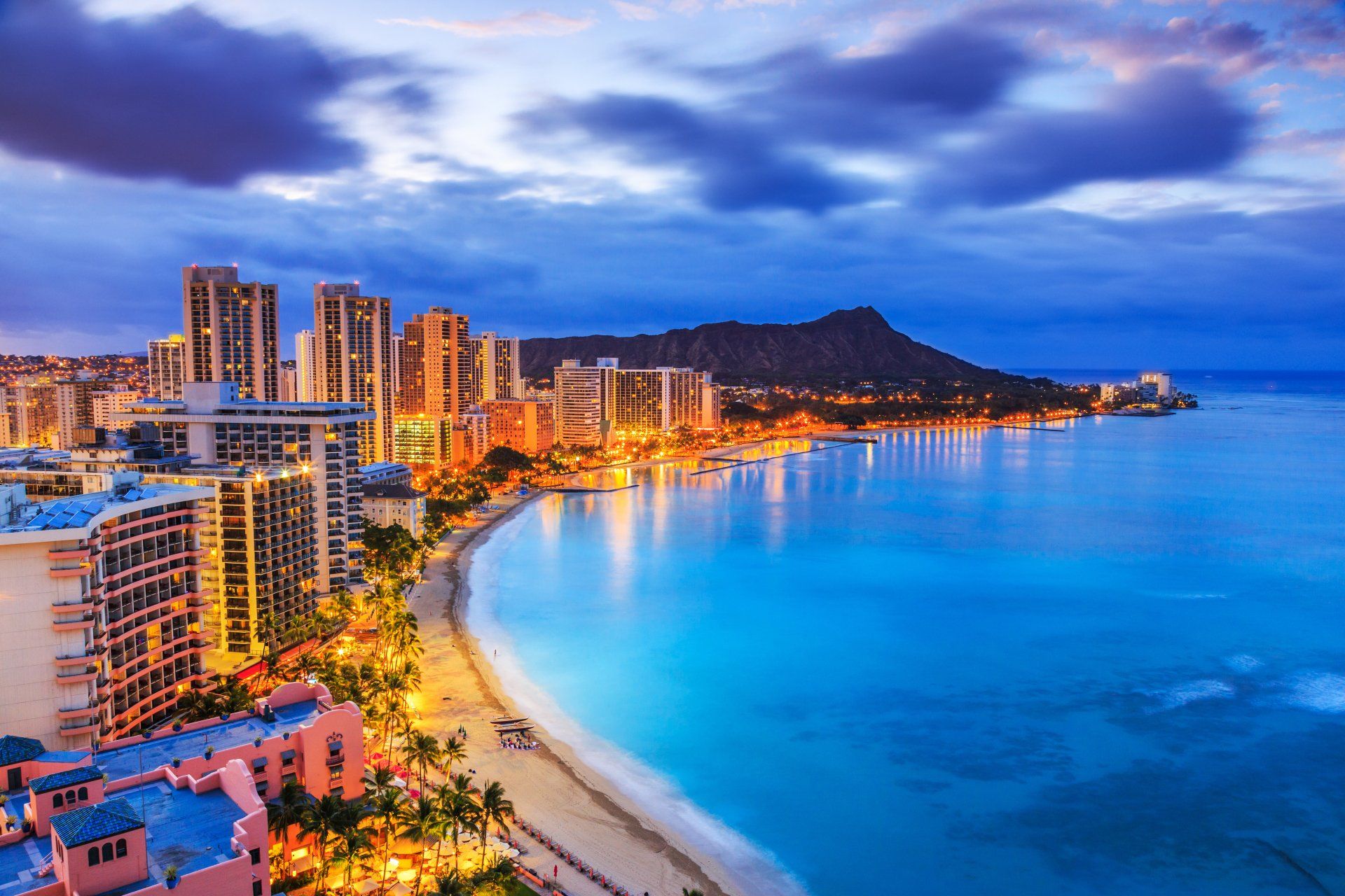 An aerial view of a city and a beach at night.