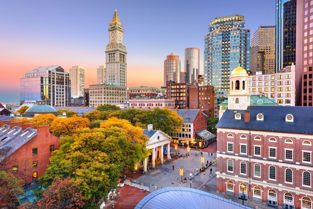 An aerial view of a city with a clock tower in the background.