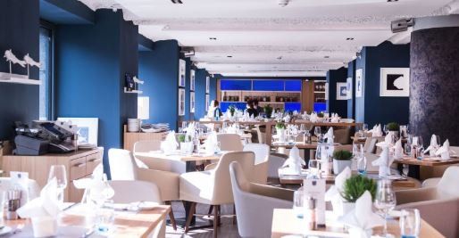 A restaurant with a lot of tables and chairs