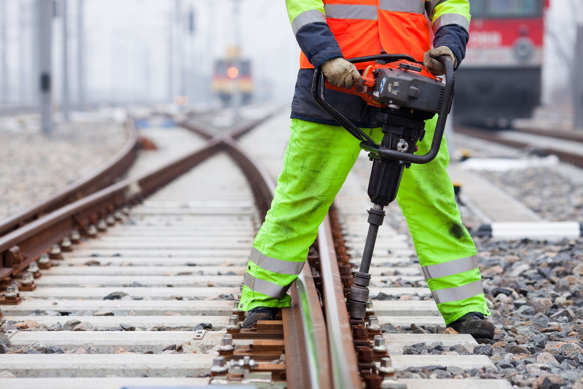 worker jackhammering rail spikes
