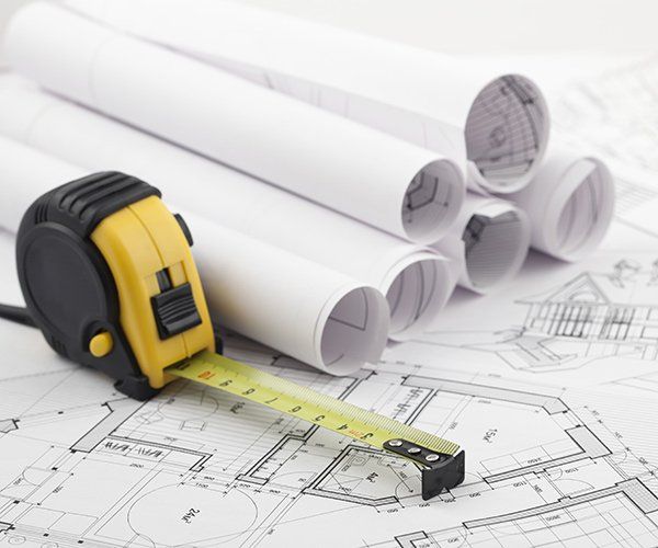 rolls of floor plans and take measurer