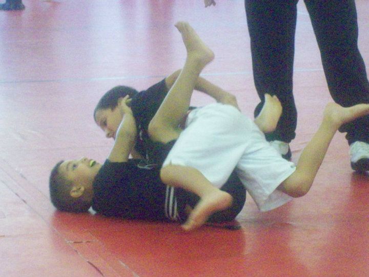 A person is holding a sparkler in their hand in the dark.