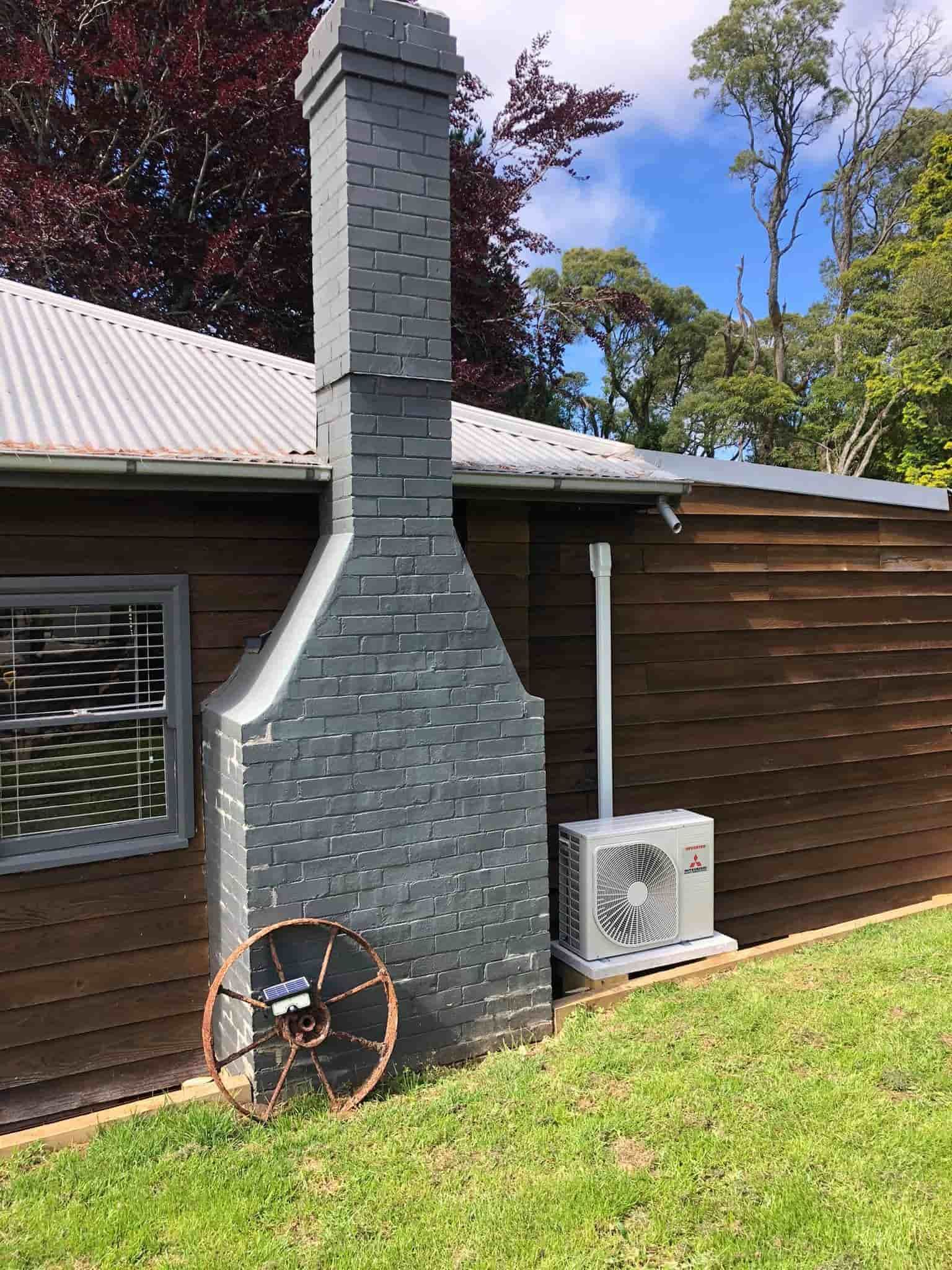 There is a Brick Chimney on the Side of a House — Steve's Air Conditioning in Lakeside Dr, NSW