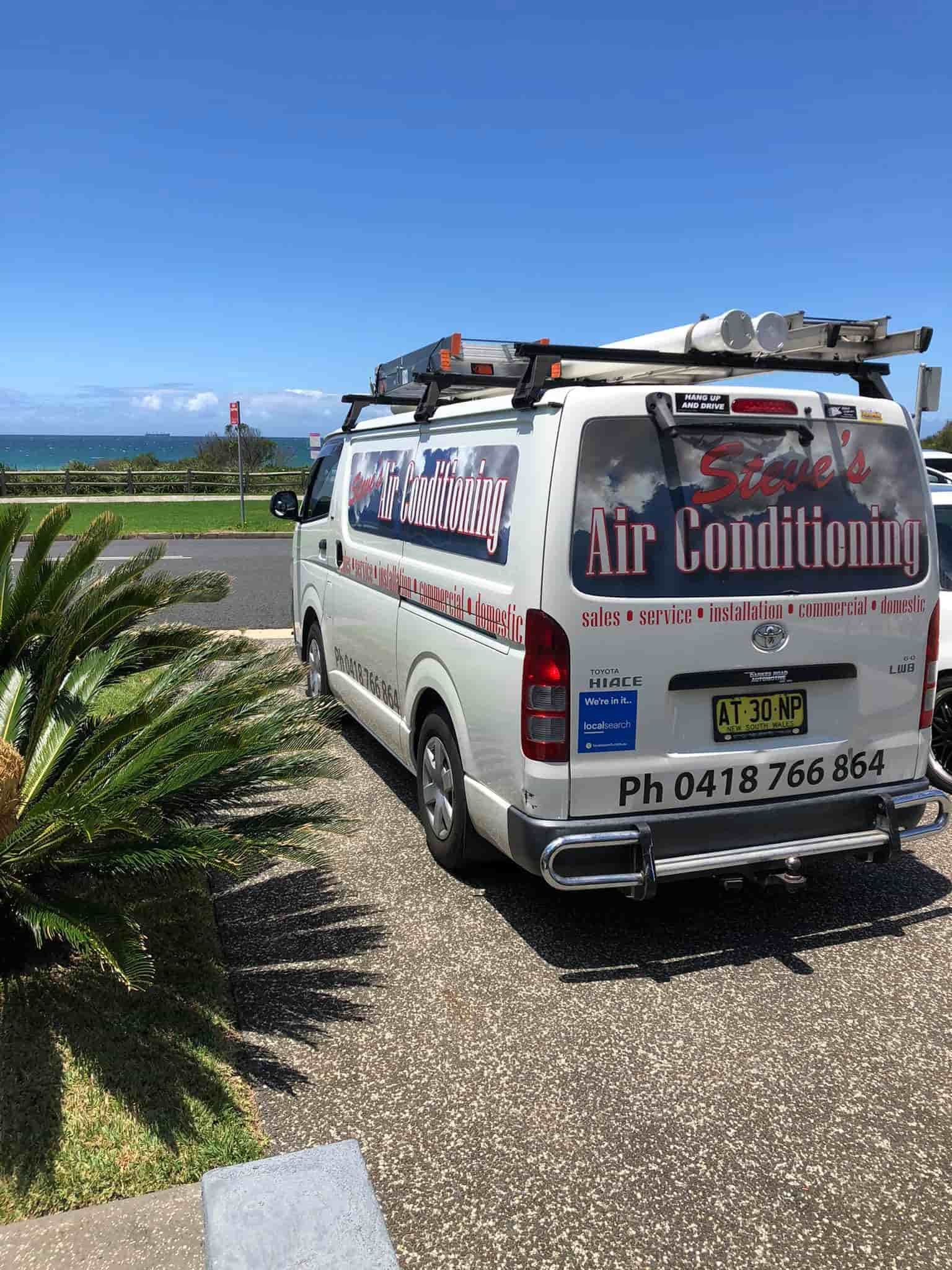 A White Van is Parked in a Driveway Next to a Palm Tree — Steve's Air Conditioning in Thirroul, NSW