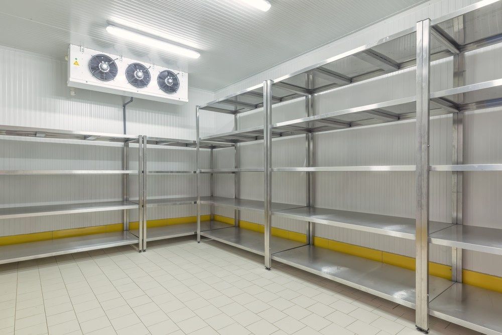 An Empty Stainless Steel Shelves in A Refrigerated Room — Magneto HVAC in Cassowary Coast, QLD