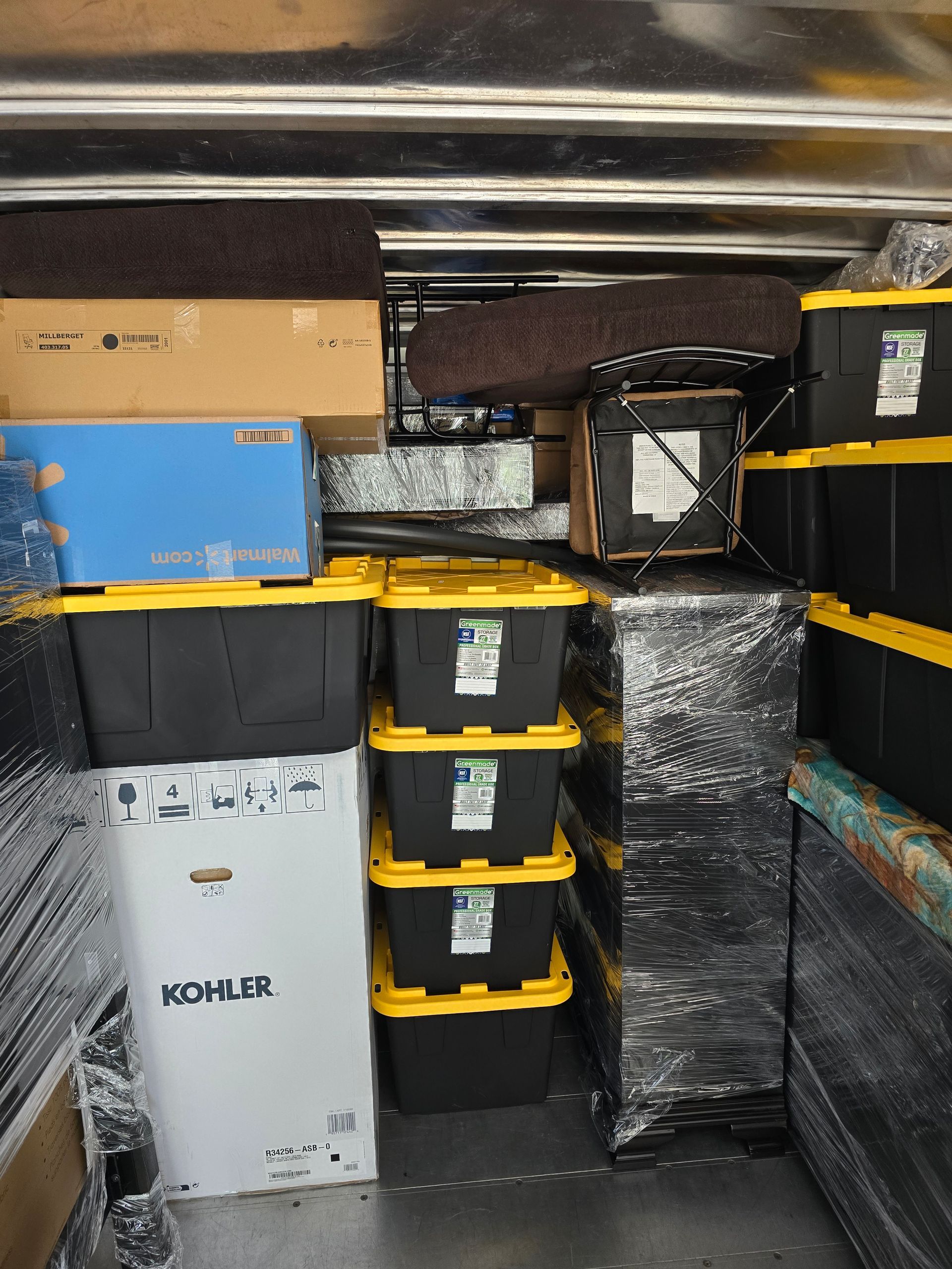 A truck is filled with lots of boxes and bins.